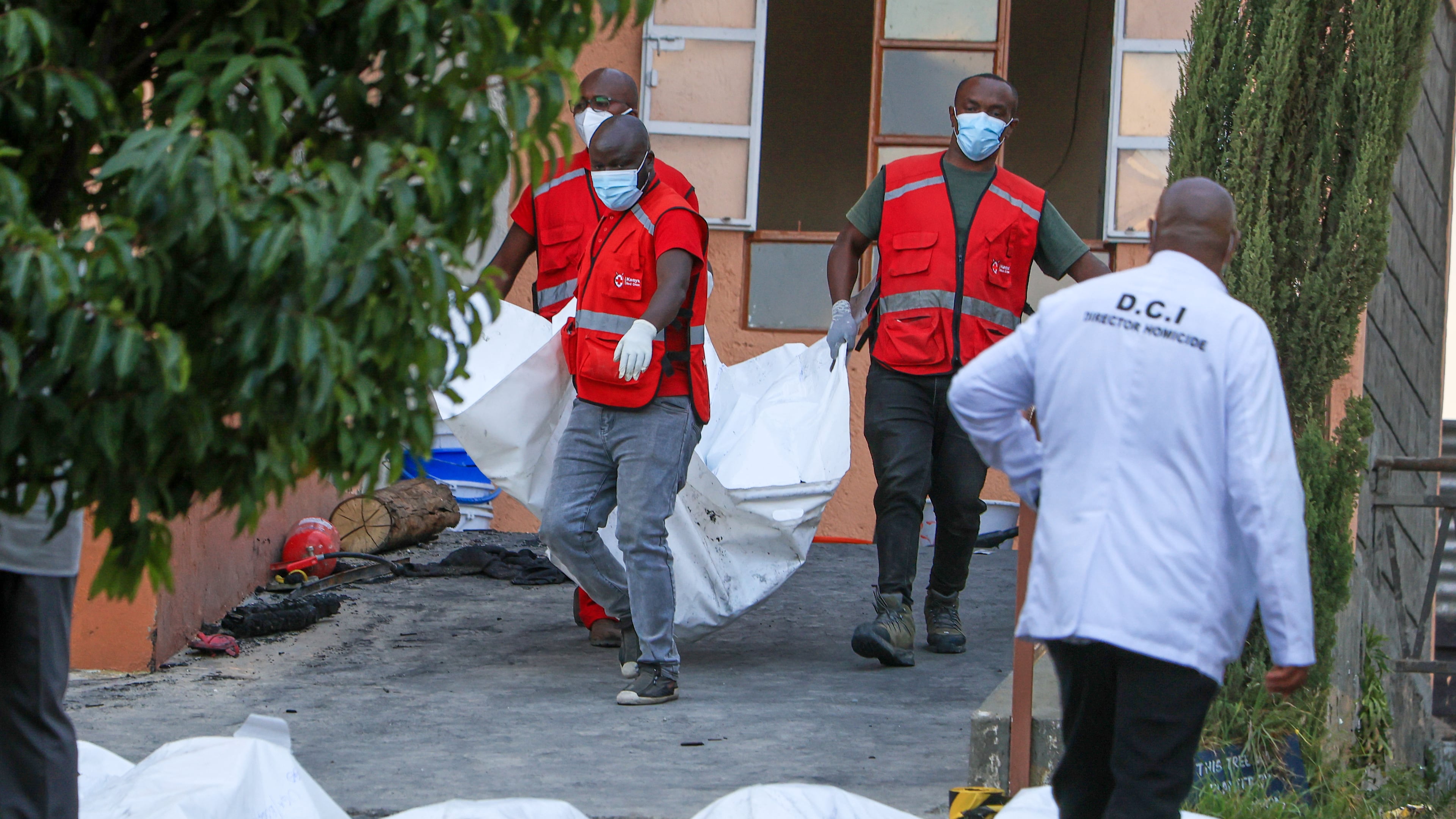 Red Cross members recover the bodies of students who died in the fire at the Utumishi Girls School in the Gilgil area, central Kenya, Thursday, May 28, 2026. (AP Photo/Andrew Kasuku)