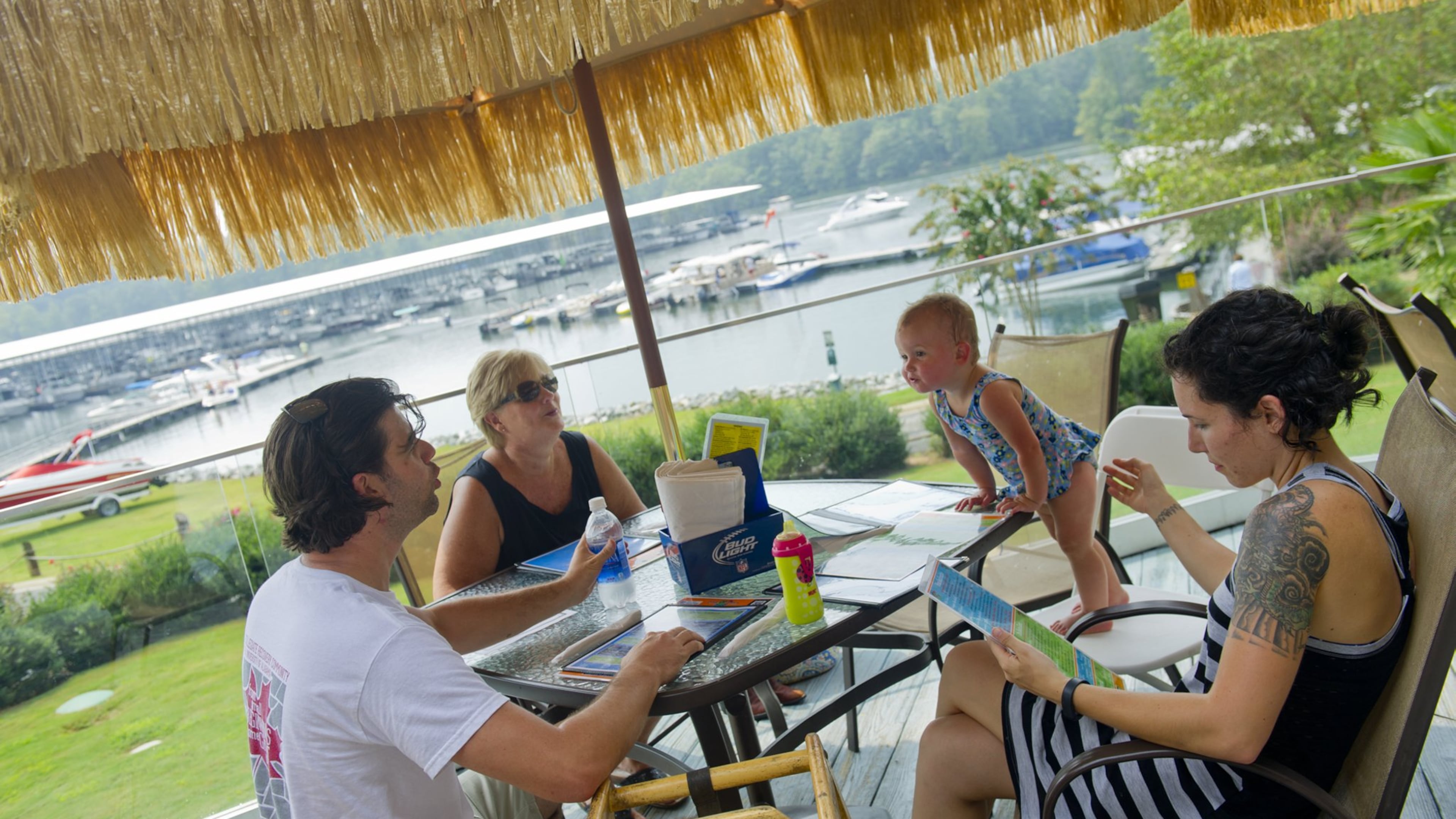 Brett Bagley (left), his mother Jill, daughter Lucy and wife Andrea decide what to eat for lunch at Fish Tales Lakeside Grille in Flowery Branch on Sunday, September 1, 2013. The restaurant, which overlooks Lake Lanier, is a popular spot to celebrate Labor Day weekend.