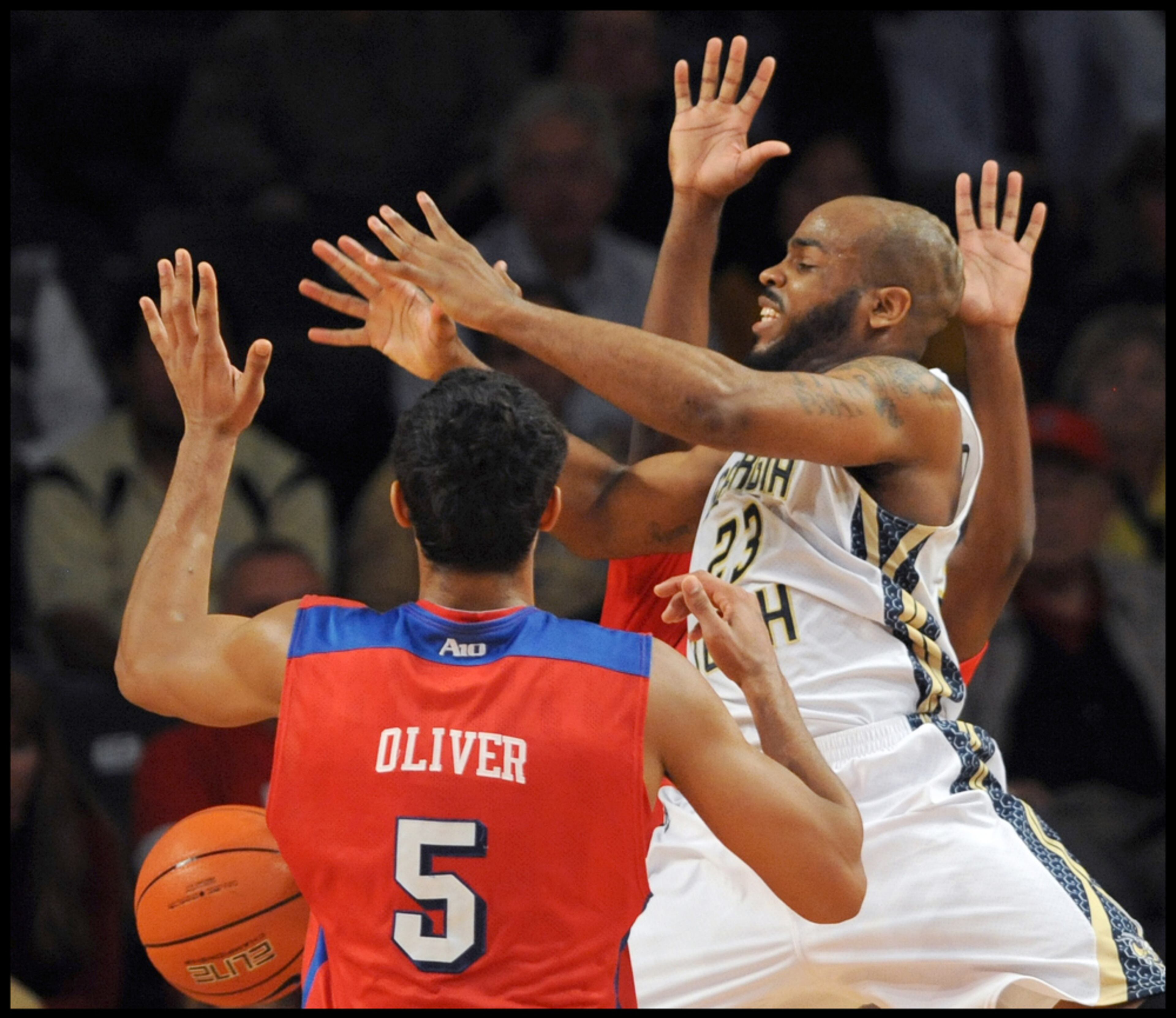 November 20, 2013 - Atlanta: I enjoy photographing basketball and I always look for photographs that show several hands on a defensive play. The University of Dayton's Devin Oliver (5) strips the basketball from the hands of Georgia Tech's Trae Golden (23) in McCamish Pavilion on Wednesday, November 20,2013, in Atlanta, Georgia. Dayton won the game 82 to 72. Camera Nikon D4, Lens 300 f2.8, ISO 2500, Aperture f2.8, Shutter speed 1/1000. JOHNNY CRAWFORD / JCRAWFORD@AJC.COM