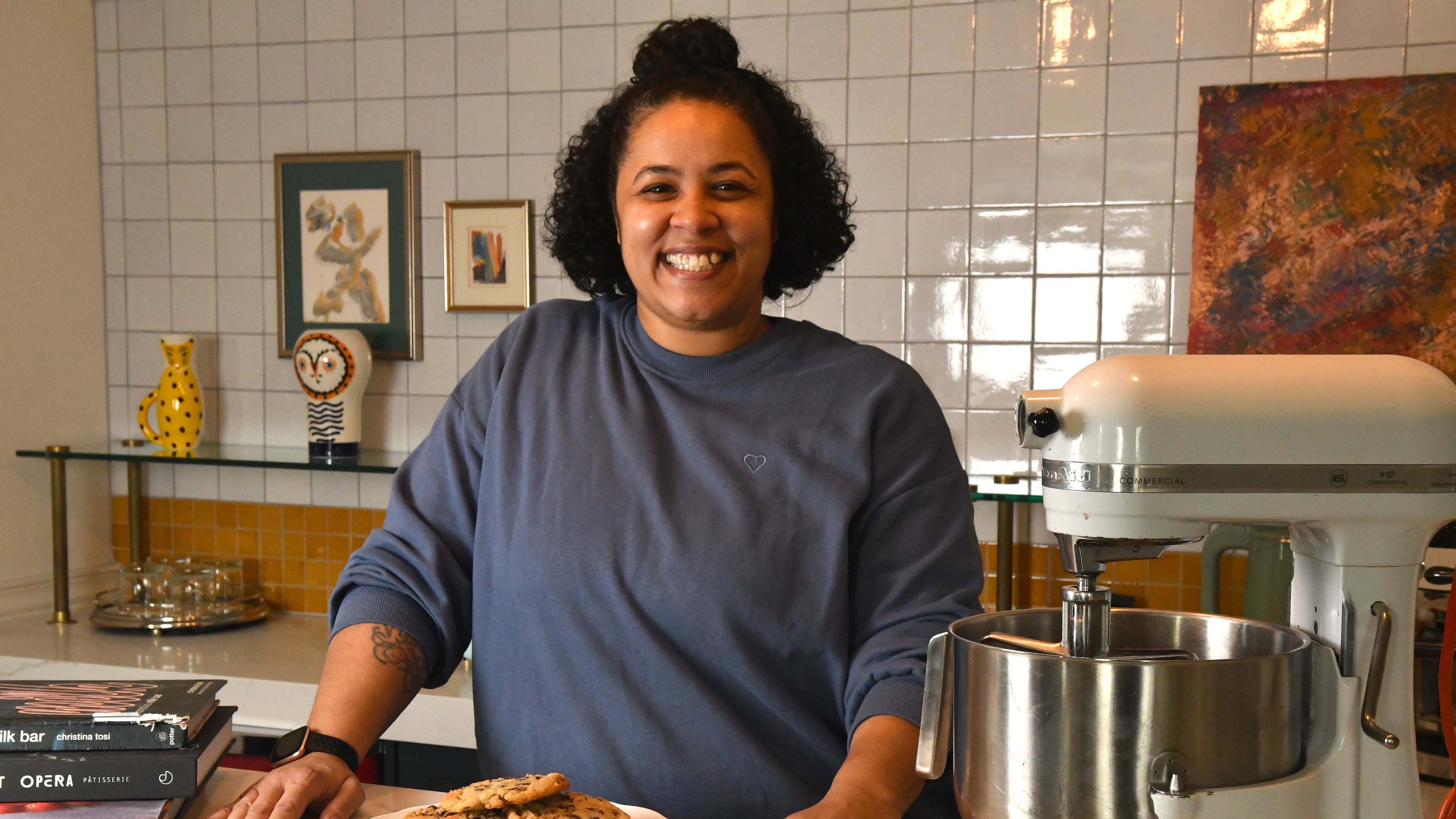 Tiny Lou's executive pastry chef Charmain Ware-Jason poses with her inspirational cookbooks, trusted KitchenAid mixer and a plate of her chocolate chip cookies. (CHRIS HUNT FOR THE ATLANTA JOURNAL-CONSTITUTION)