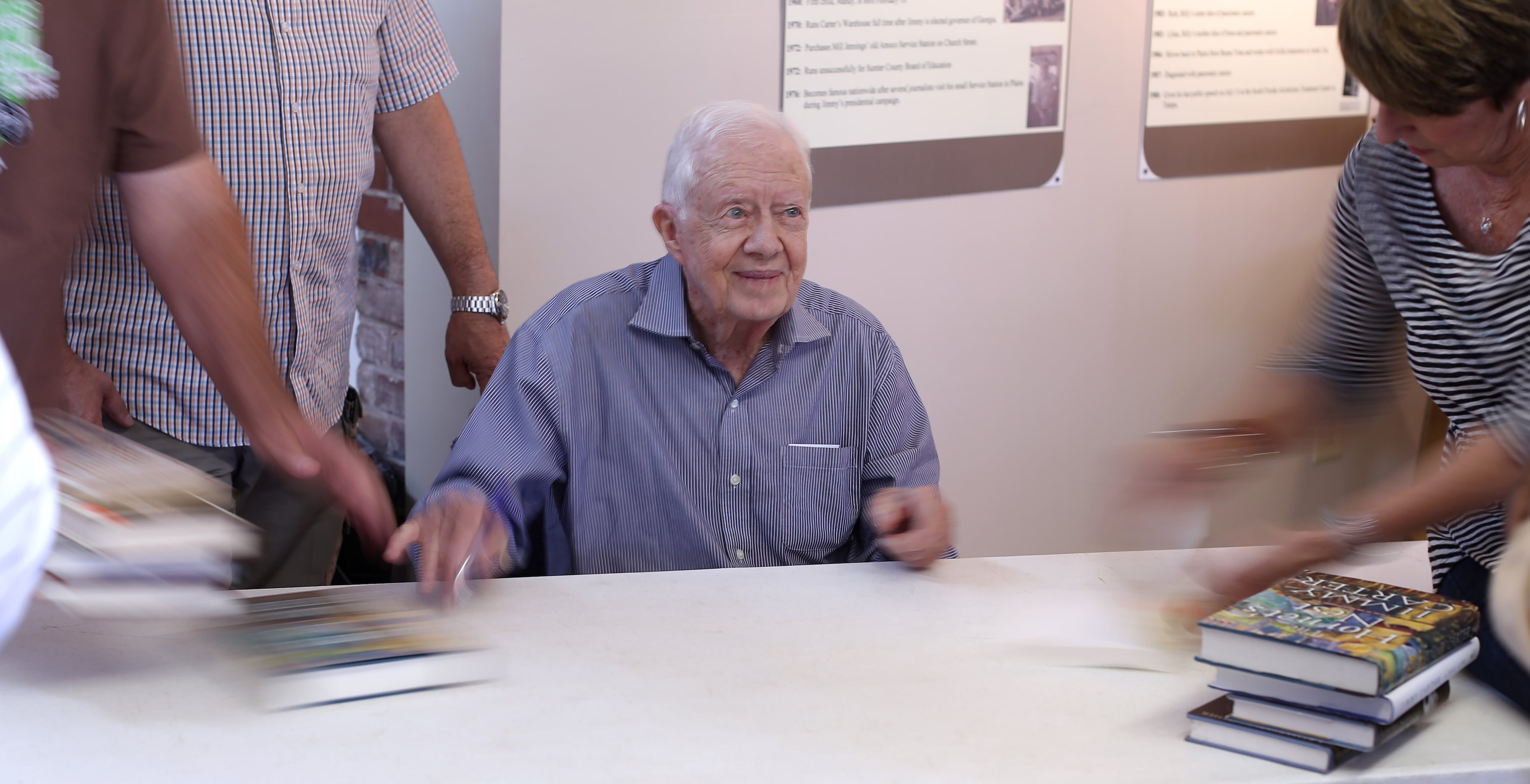 Former President Jimmy Carter speeds through autographing books during one of his many appearances at the Plains Festival on Saturday September 26, 2015 in Plains. Carter signed 895 books in an hour and 20 minutes during the festival, but friends said that he's slowed down from the 1,000 books an hour he used to be able to sign. Ben Gray / bgray@ajc.com