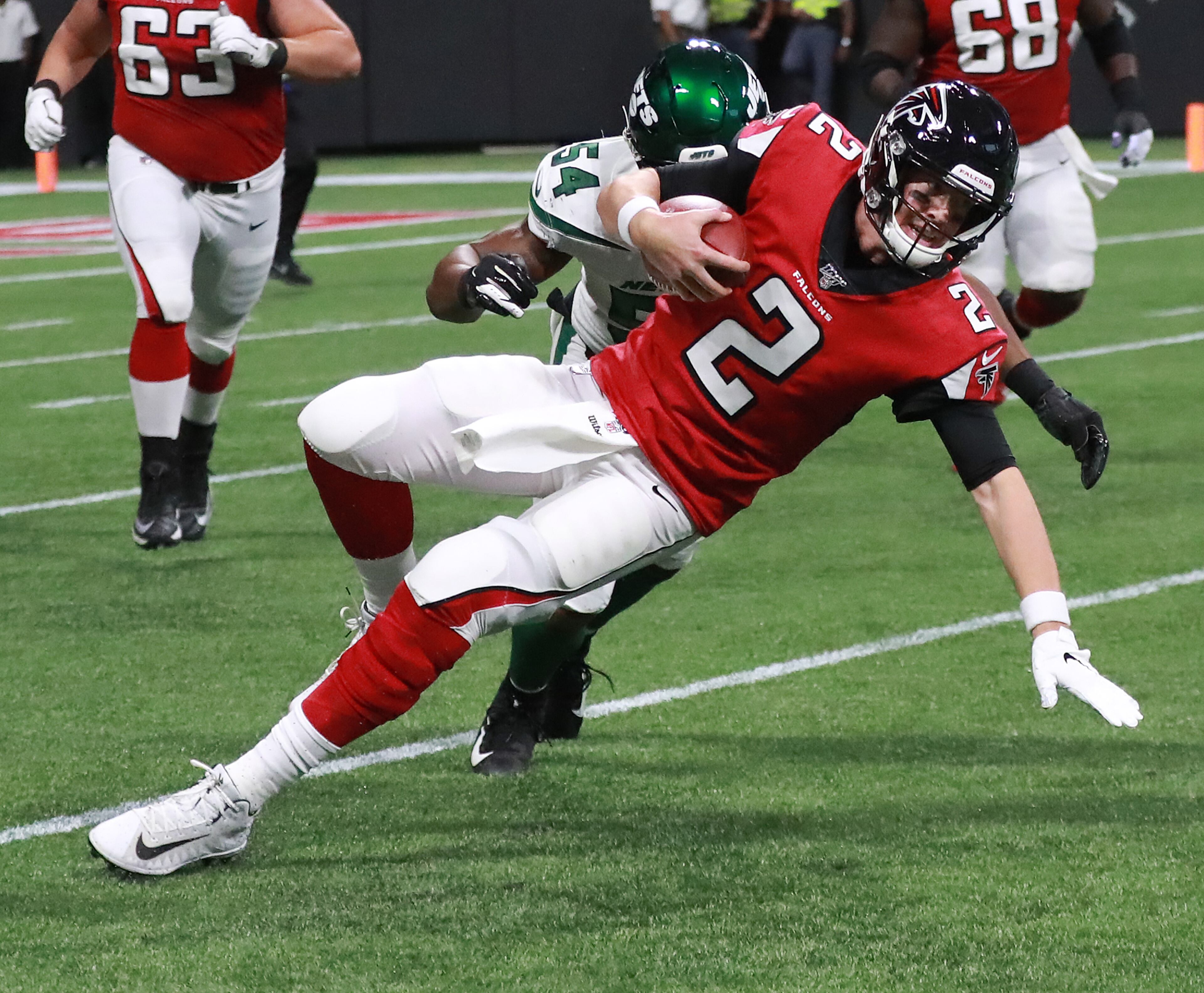 Falcons quarterback Matt Ryan is tackled by New York Jets linebacker Avery Williamson during the first quarter in a NFL preseason game on Thursday in Atlanta. Curtis Compton/ccompton@ajc.com