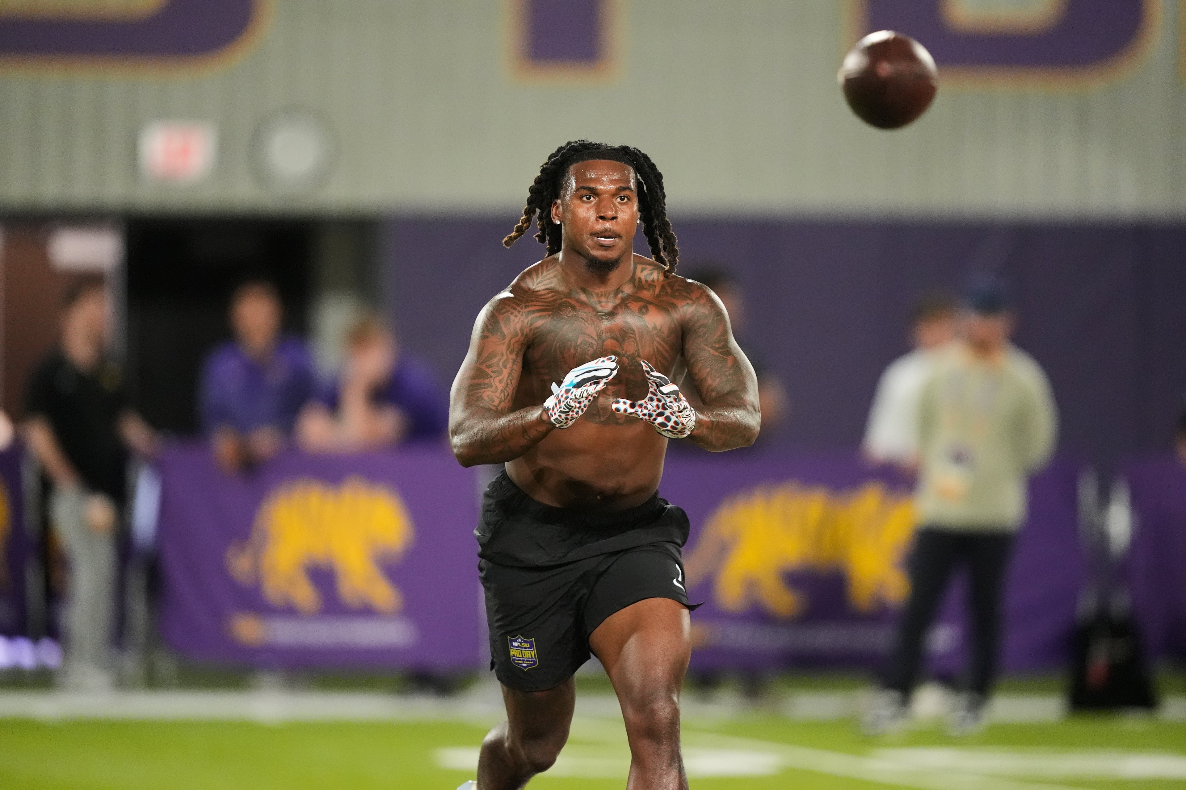 LSU linebacker Harold Perkins Jr. (7) goes through workouts with LSU offensive lineman Josh Thompson (56) during their NFL football pro day, Monday, March 23, 2026, in Baton Rouge, La. (AP Photo/Gerald Herbert)