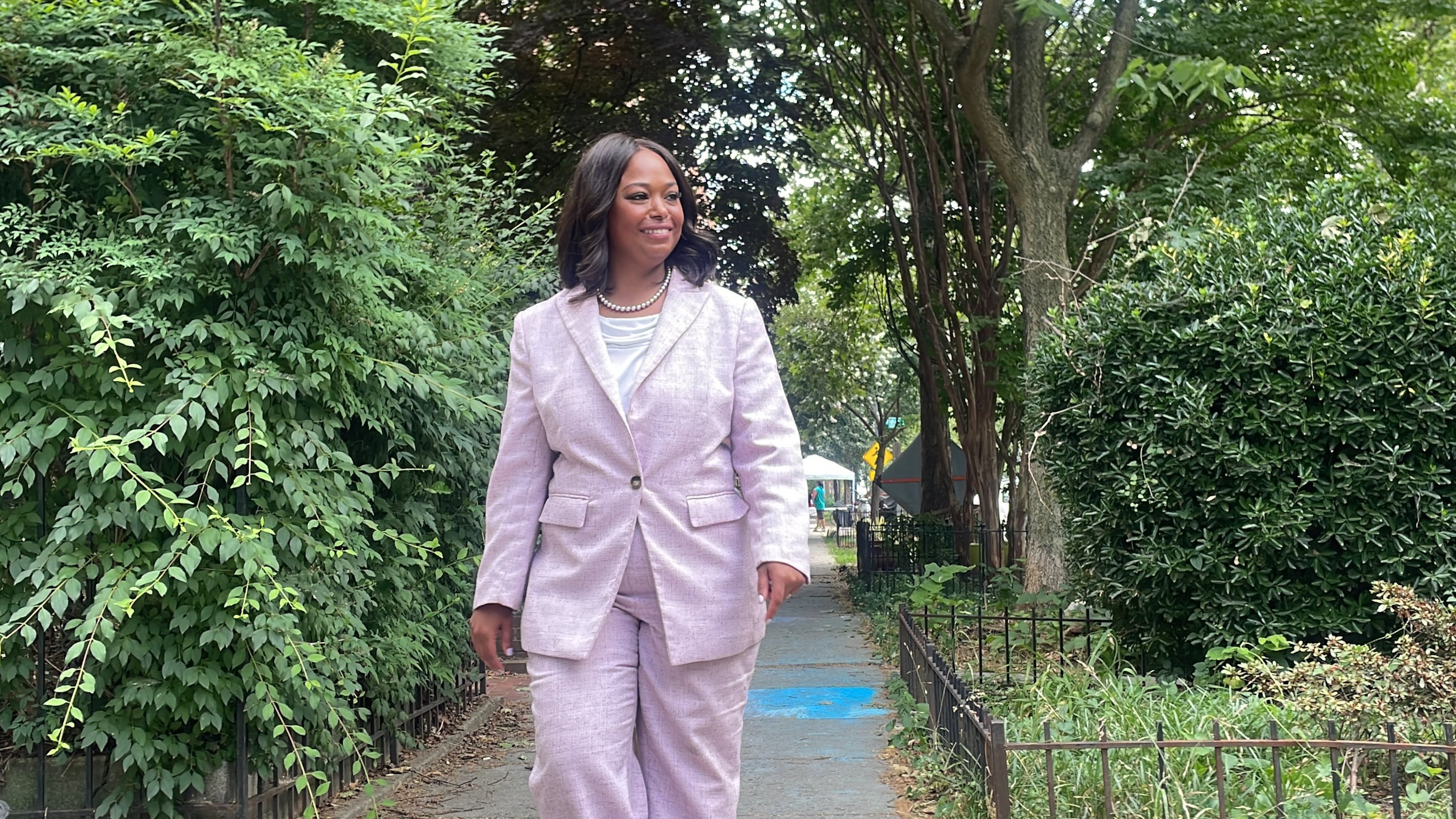 District of Columbia mayoral candidate Janeese Lewis George walks down a street while canvassing in a Washington, neighborhood, Monday, June 15, 2026. (AP Photo/Matt Brown)