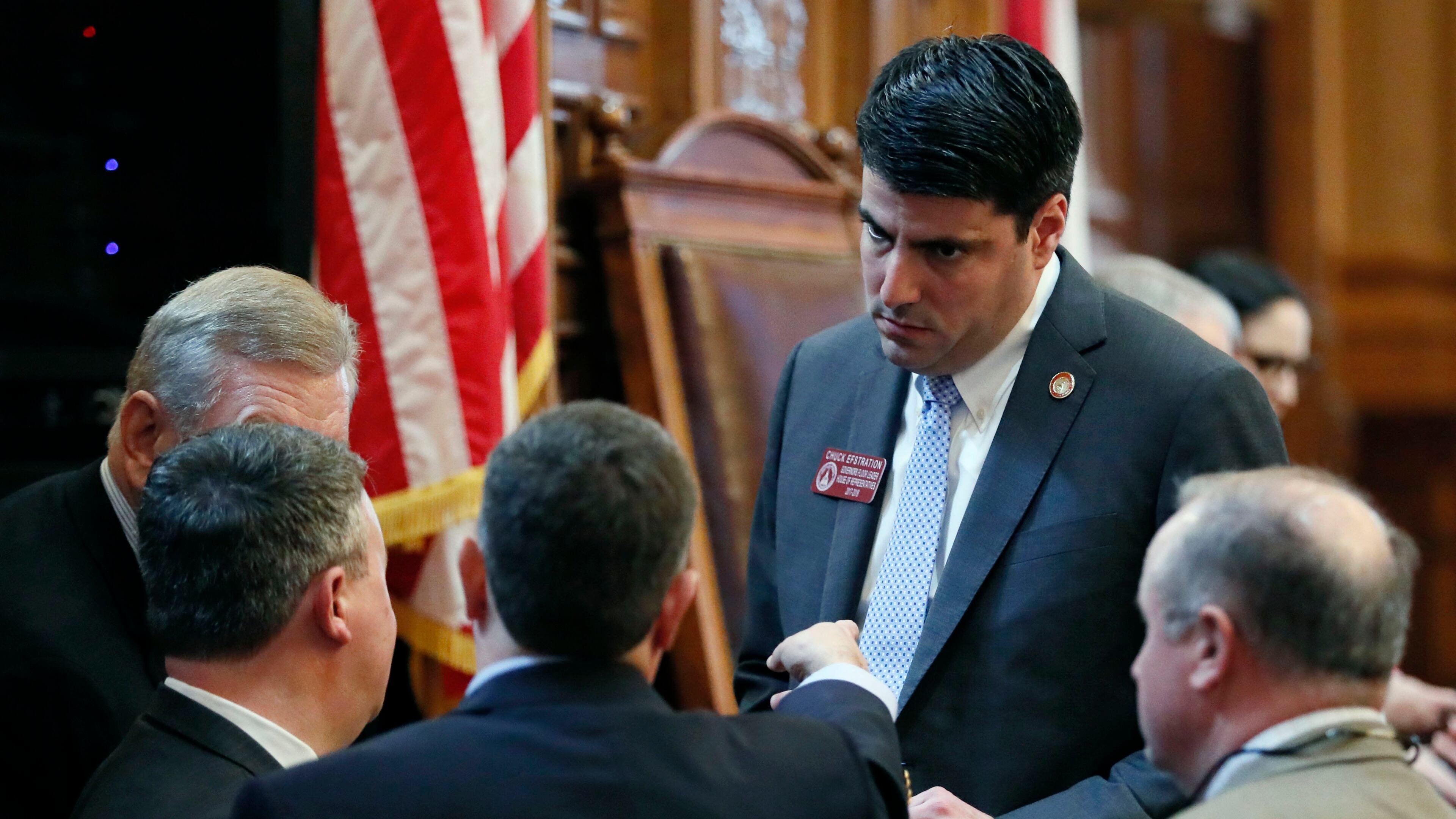 Atlanta - Rep. Chuck Efstration, R - Dacula, one of Gov. Brian Kemp's floor leaders, huddles with colleagues on the House Floor earlier in the 2019 session. BOB ANDRES /BANDRES@AJC.COM