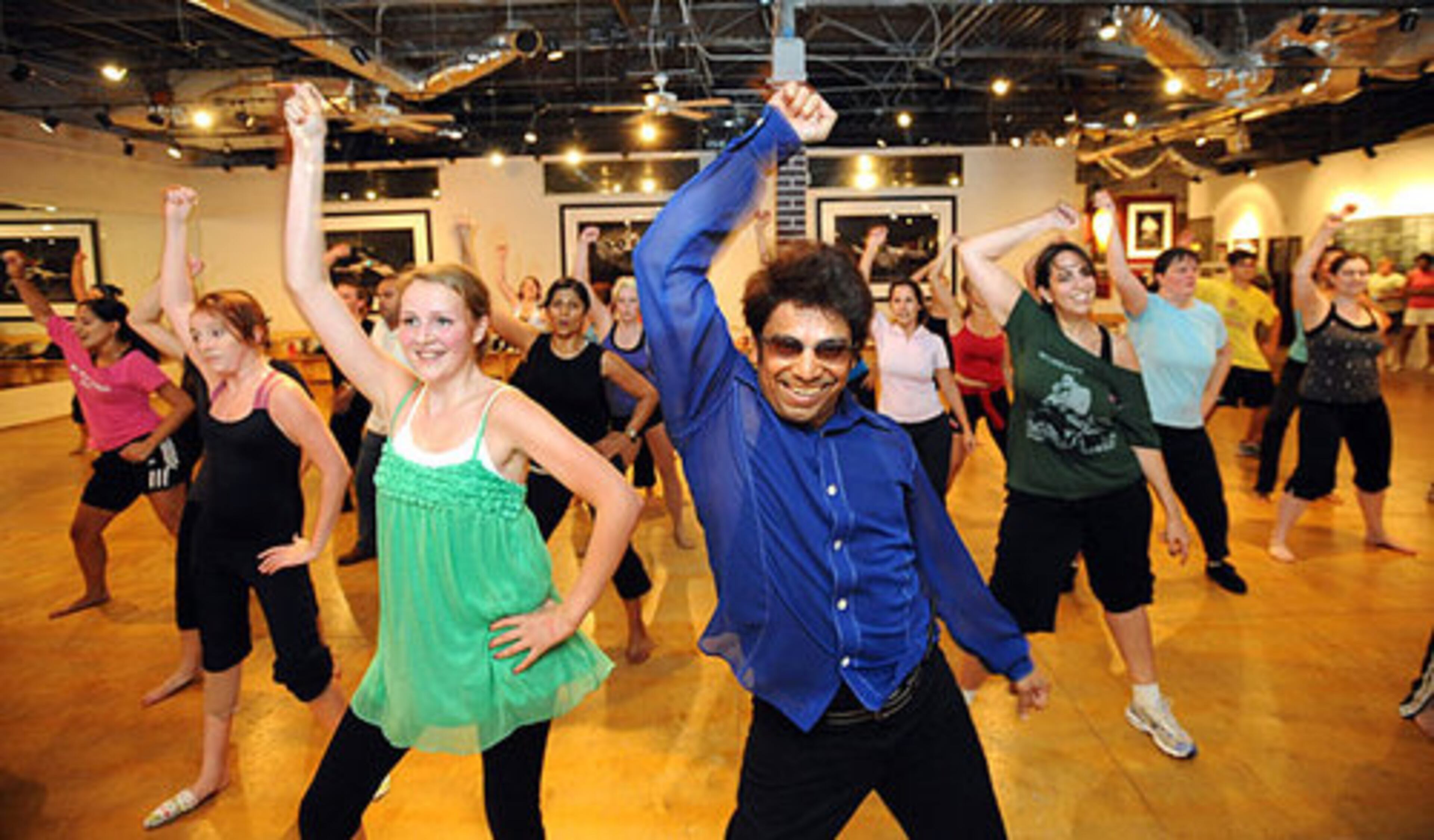 "Slumdog Millionaire" choreographer Longinus Fernandes (center) shows some motions during the bollywood master class Thursday night at Dance 101 in Atlanta.