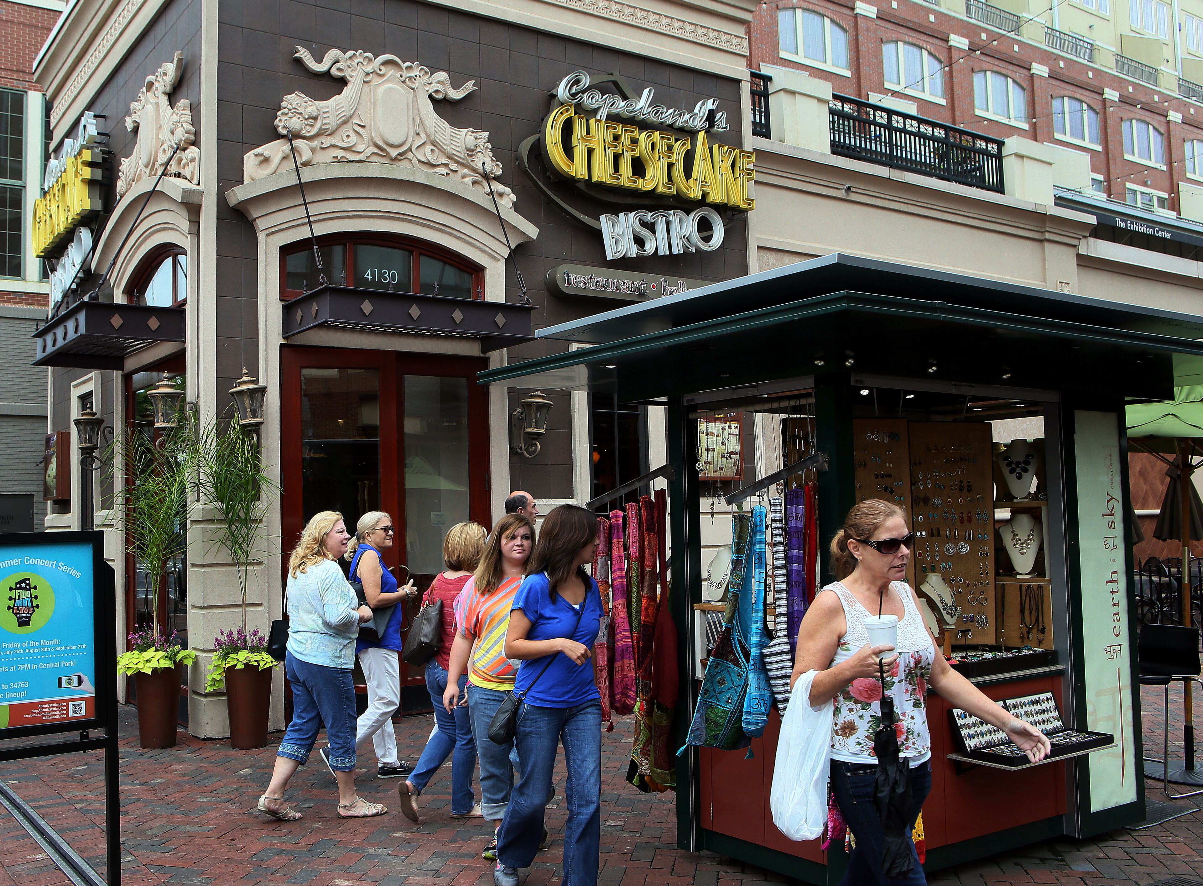 Shoppers stroll past Copeland's Cheesecake Bistro at Atlantic Station in Atlanta.