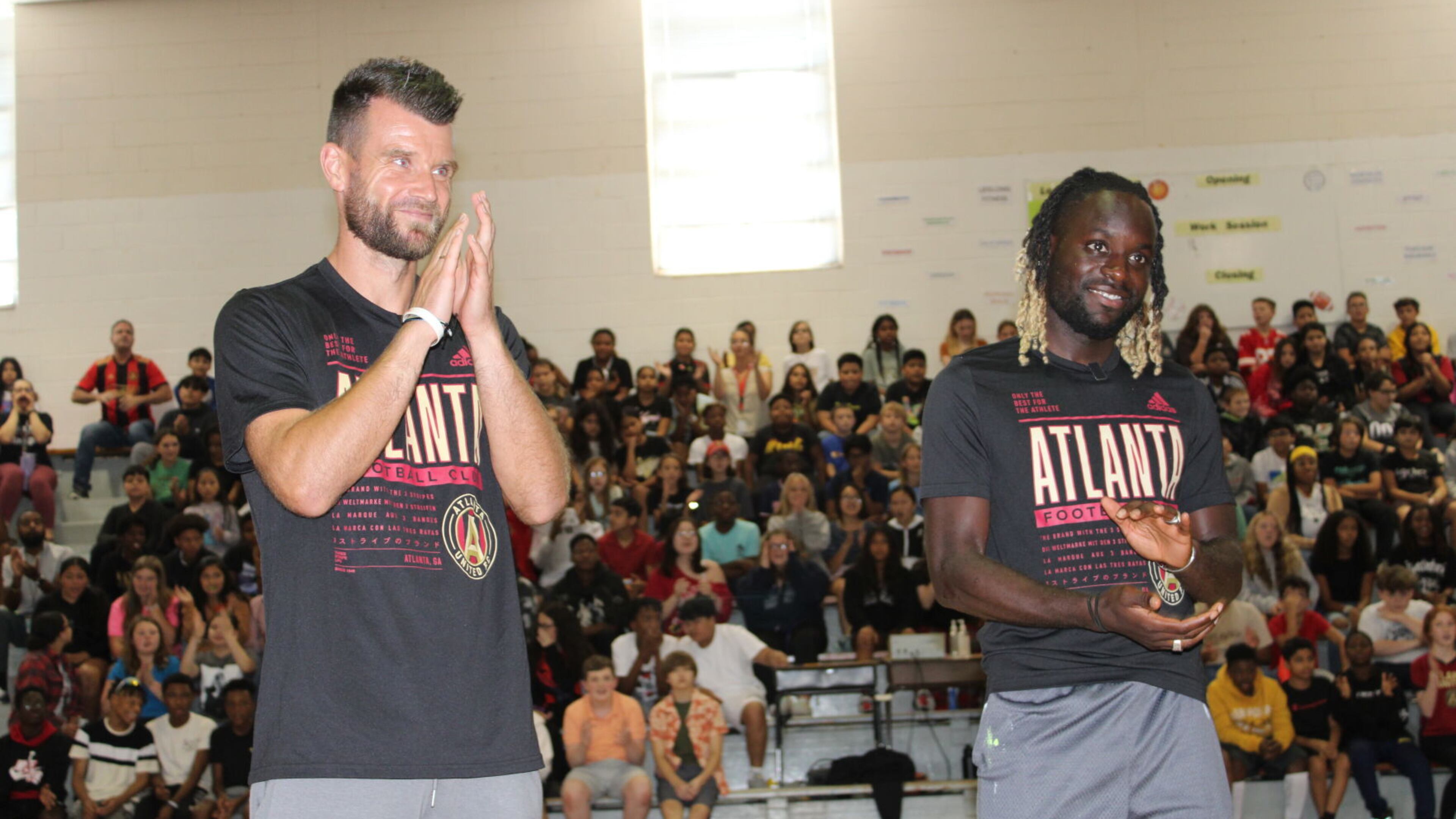 Atlanta United players Quentin Westberg, left, and Tristan Muyumba surprise students at Daniell Middle School during a pep rally on Thursday. (Photo Courtesy of Jake Busch)