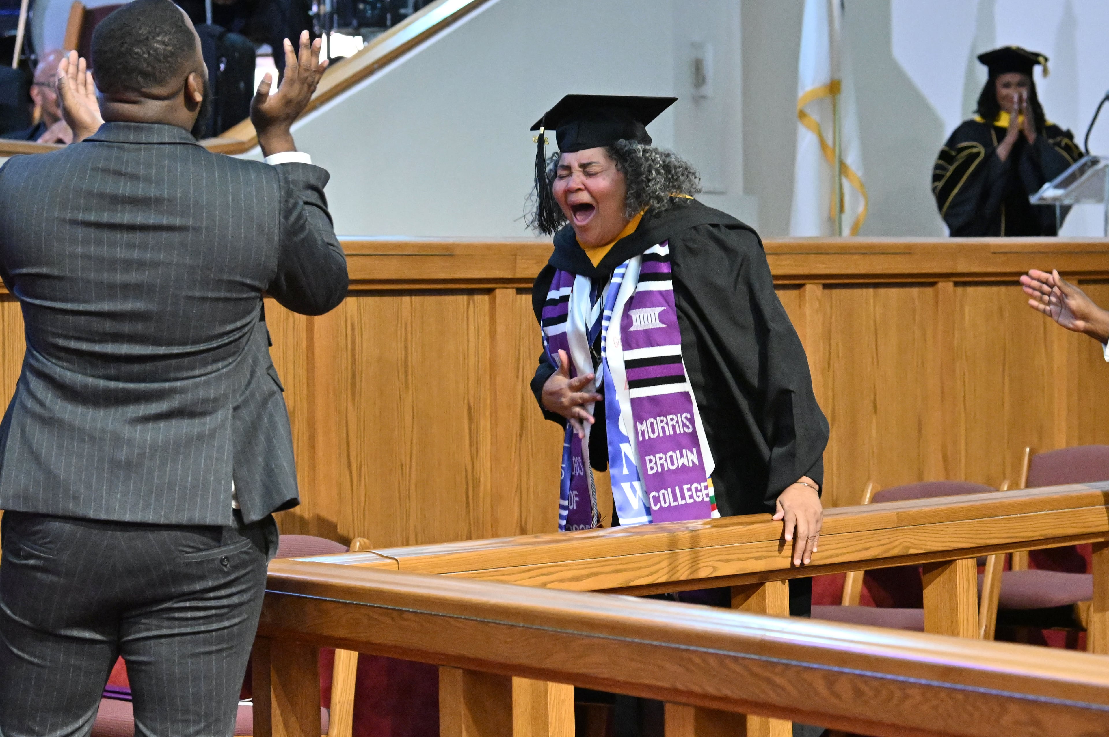 Artrisia Edwards reacts before she receives her degree during 2025 Morris Brown College commencement exercises at Saint Philip A.M.E. Church, Saturday, May 17, 2025, in Atlanta. (Hyosub Shin / AJC)