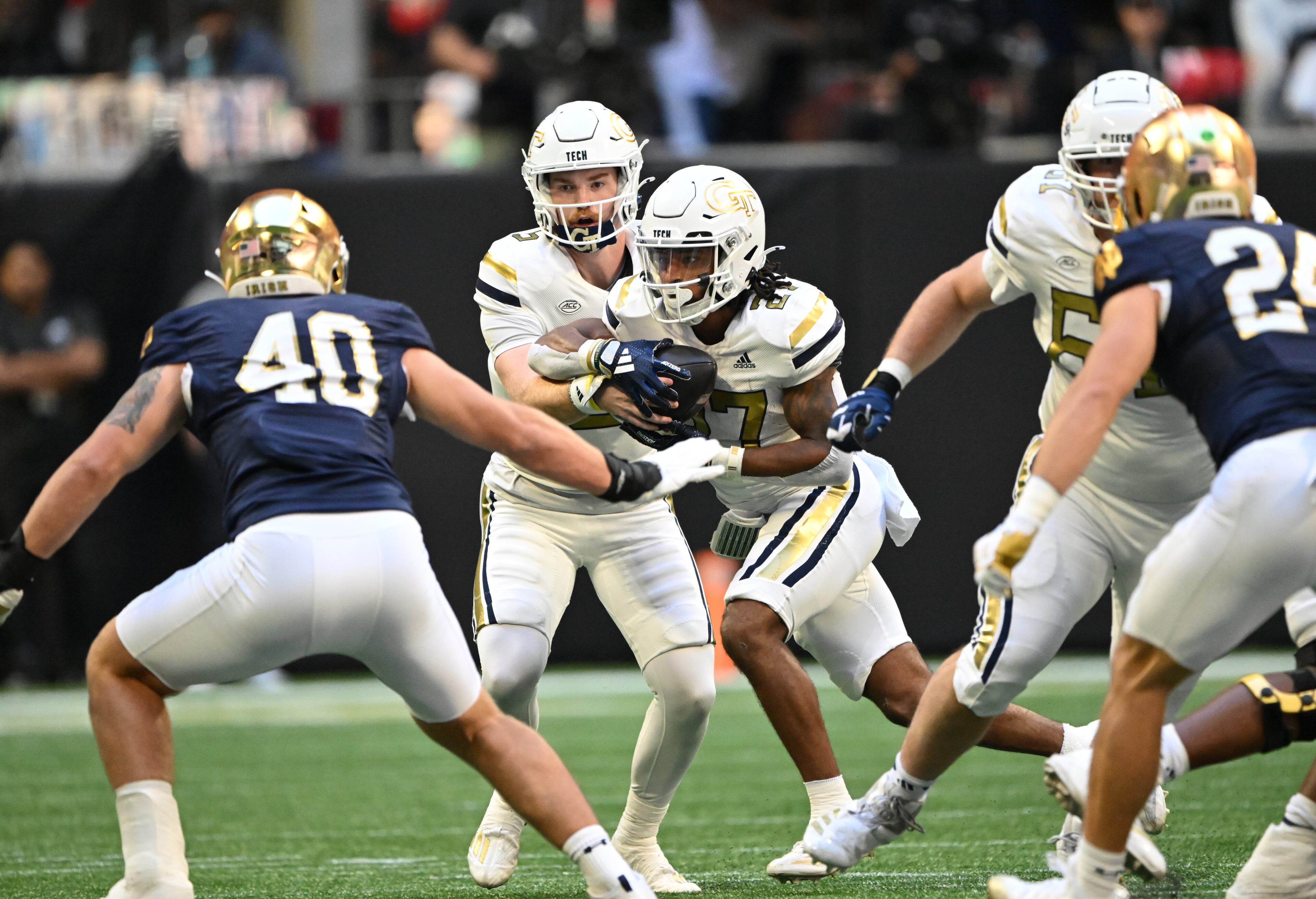 Georgia Tech quarterback Zach Pyron (5) makes a handoff to Georgia Tech running back Chad Alexander (27) during the first half in an NCAA football game at Mercedes-Benz Stadium, Saturday, October 19, 2024, in Atlanta. (Hyosub Shin / AJC)