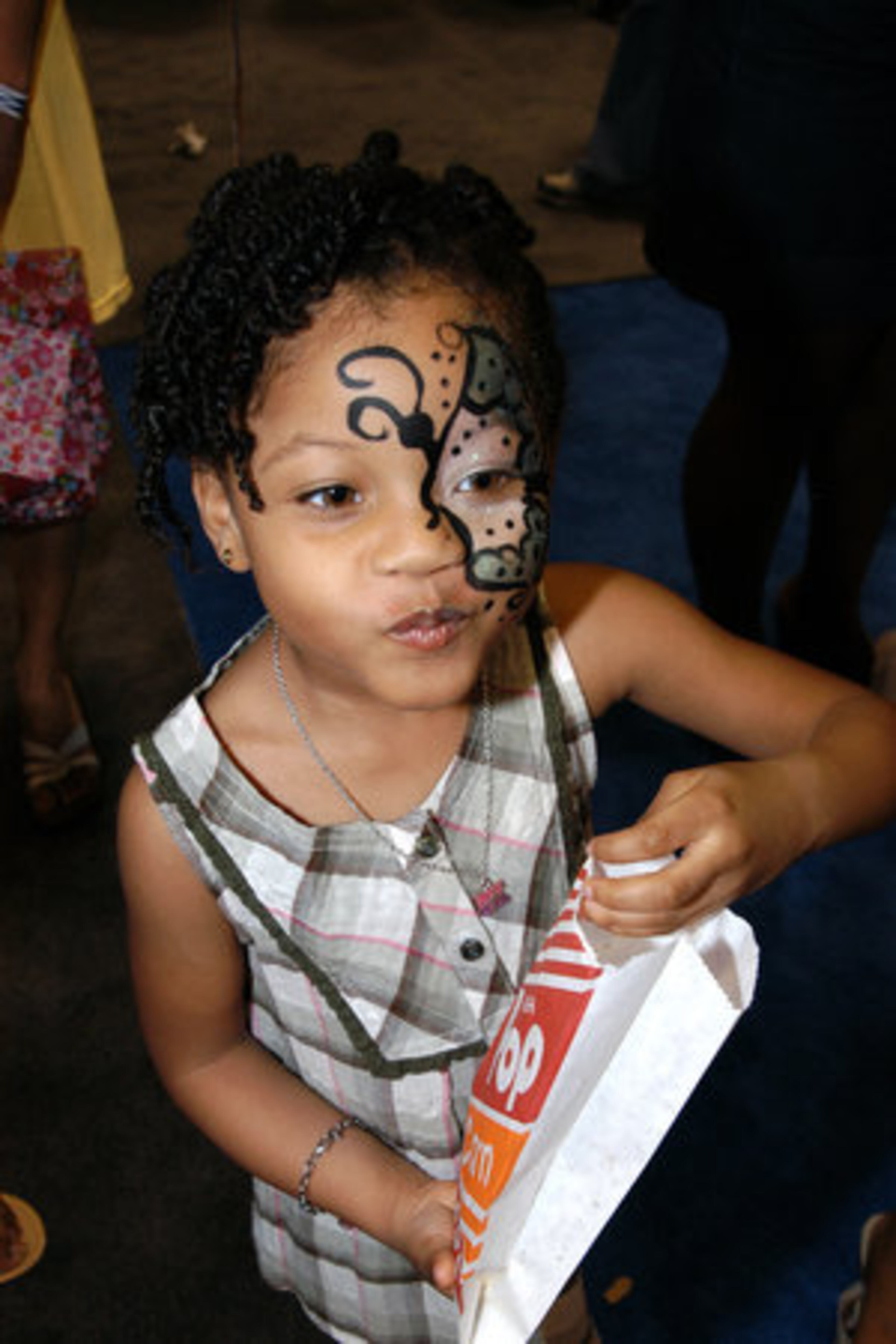 Popcorn and face painting were a hit with Kendall Petties, 4, and other kids at the Natural Hair and Beauty Show.