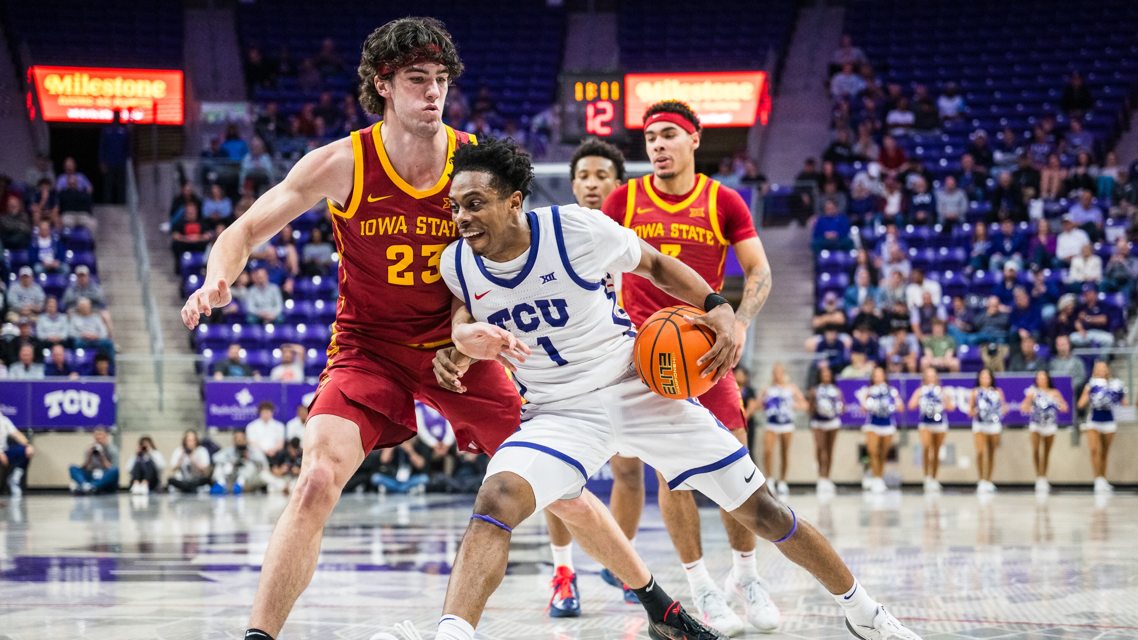 TCU guard Jayden Pierre (1) drives the ball against Iowa State forward Blake Buchanan (23) during an NCAA college basketball game, Tuesday, Feb. 10, 2026, Fort Worth, Texas. (AP Photo/Jessica Tobias)