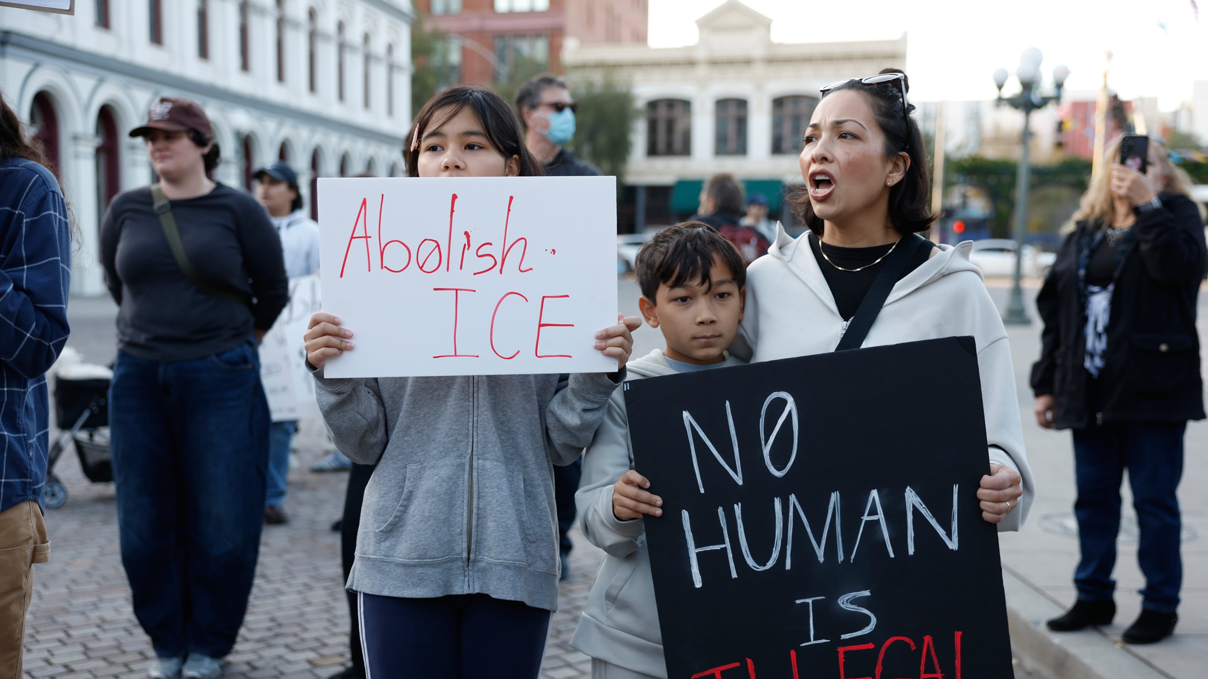 Demonstrators hold signs during a protest in response to the fatal shooting of 37-year-old Alex Pretti in Minneapolis earlier in the day Saturday, Jan. 24, 2026, in Los Angeles. (AP Photo/Caroline Brehman)