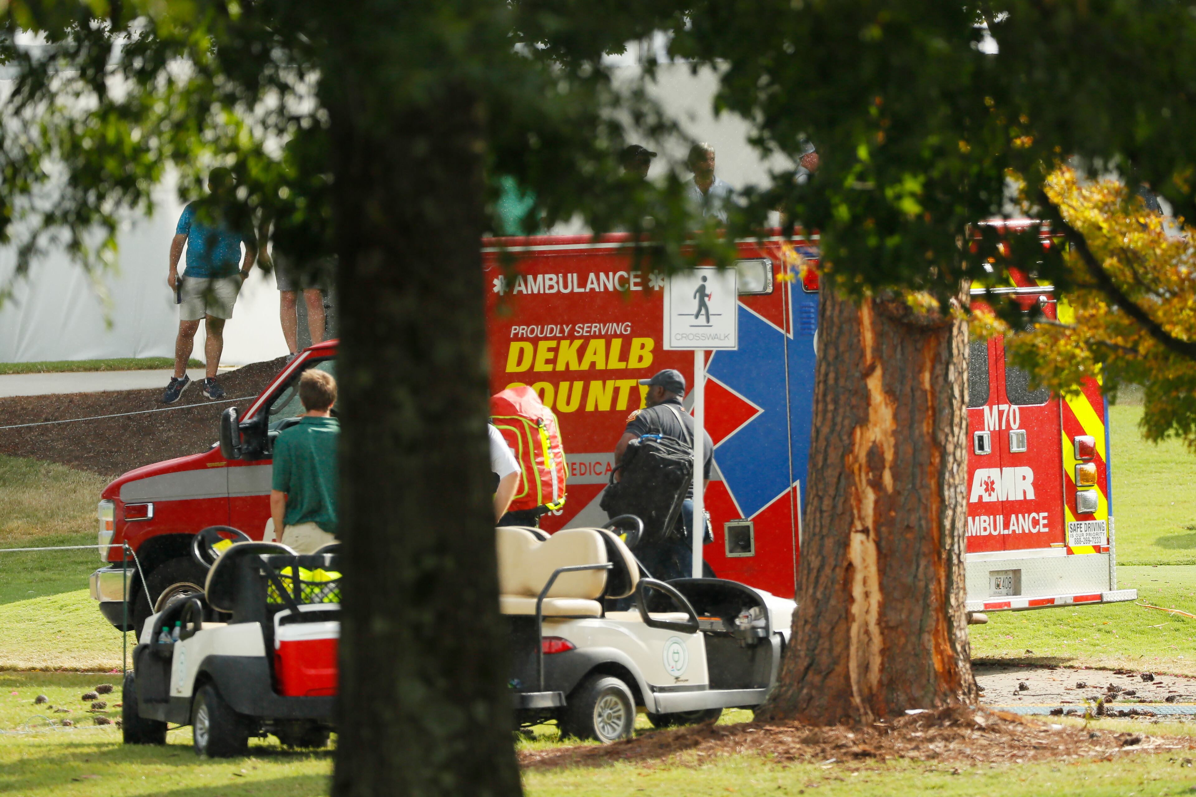 ATLANTA, GEORGIA - AUGUST 24: Emergency services provide assistance next to a tree damaged by a lightning strike during a suspension in play of the third round of the TOUR Championship at East Lake Golf Club on August 24, 2019 in Atlanta, Georgia. (Photo by Kevin C. Cox/Getty Images)