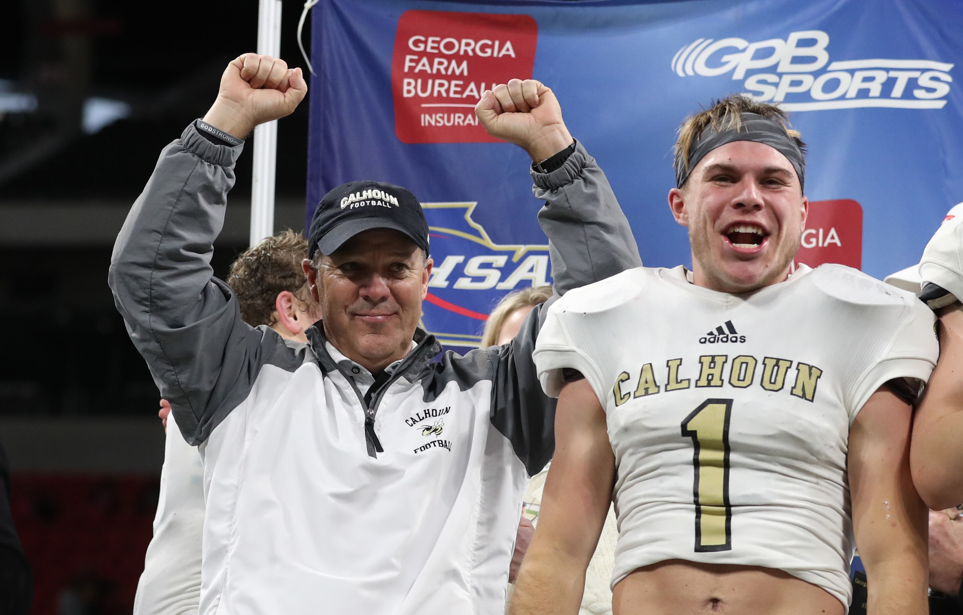 Calhoun head coach Hal Lamb, left, and wide receiver Porter Law (1) celebrate after their win against Peach County during the Class AAA Championship at Mercedes-Benz Stadium Friday, December 8, 2017, in Atlanta. Calhoun won 10-6. PHOTO / JASON GETZ