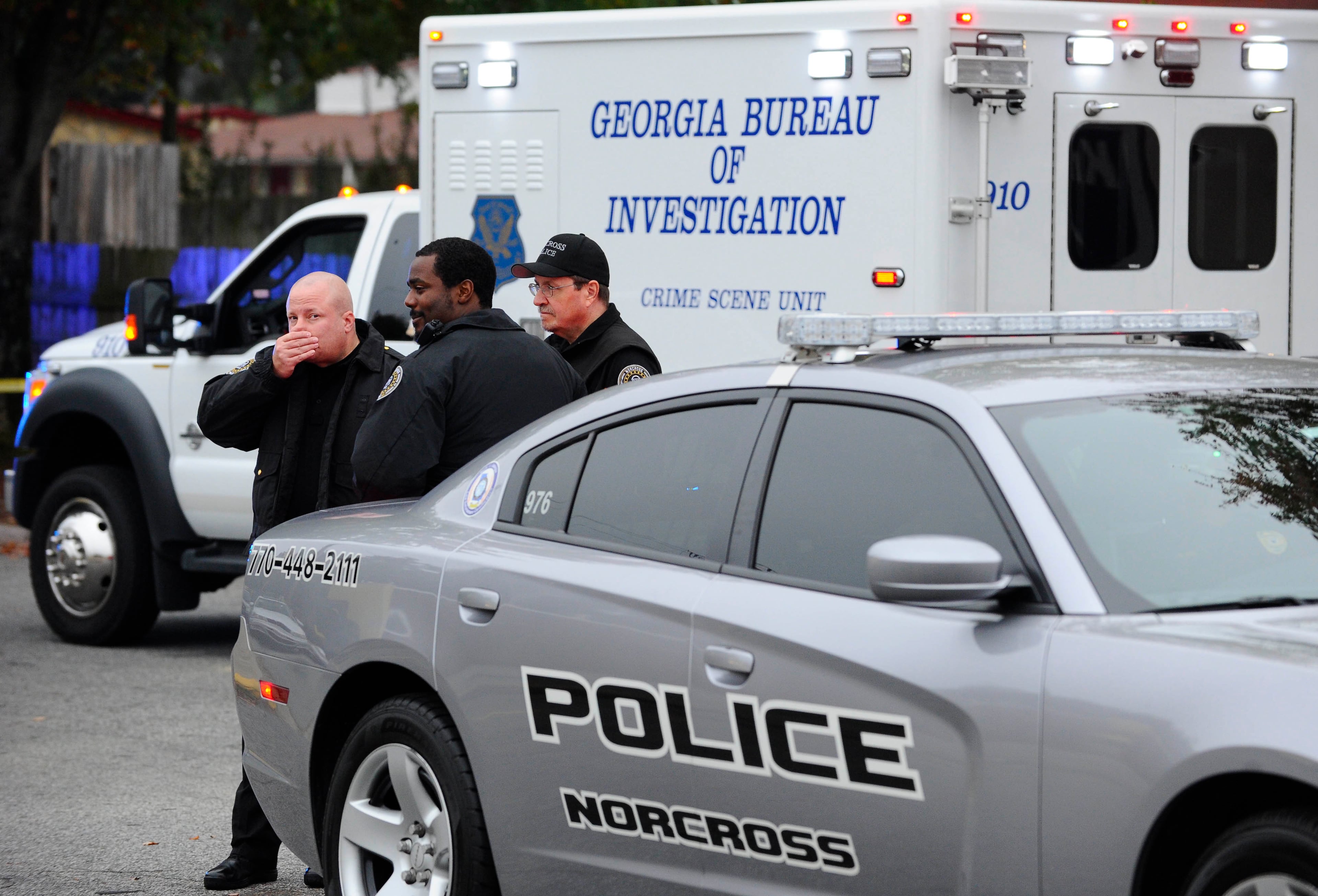 Norcross police and the GBI investigate an officer-involved shooting at the Fusion Event Hall parking lot next to a Knights Inn motel and the adjacent Waffle House at Indian Trail Road and Brook Hollow Parkway on Monday, Oct. 13, 2014, in Norcross, Ga.