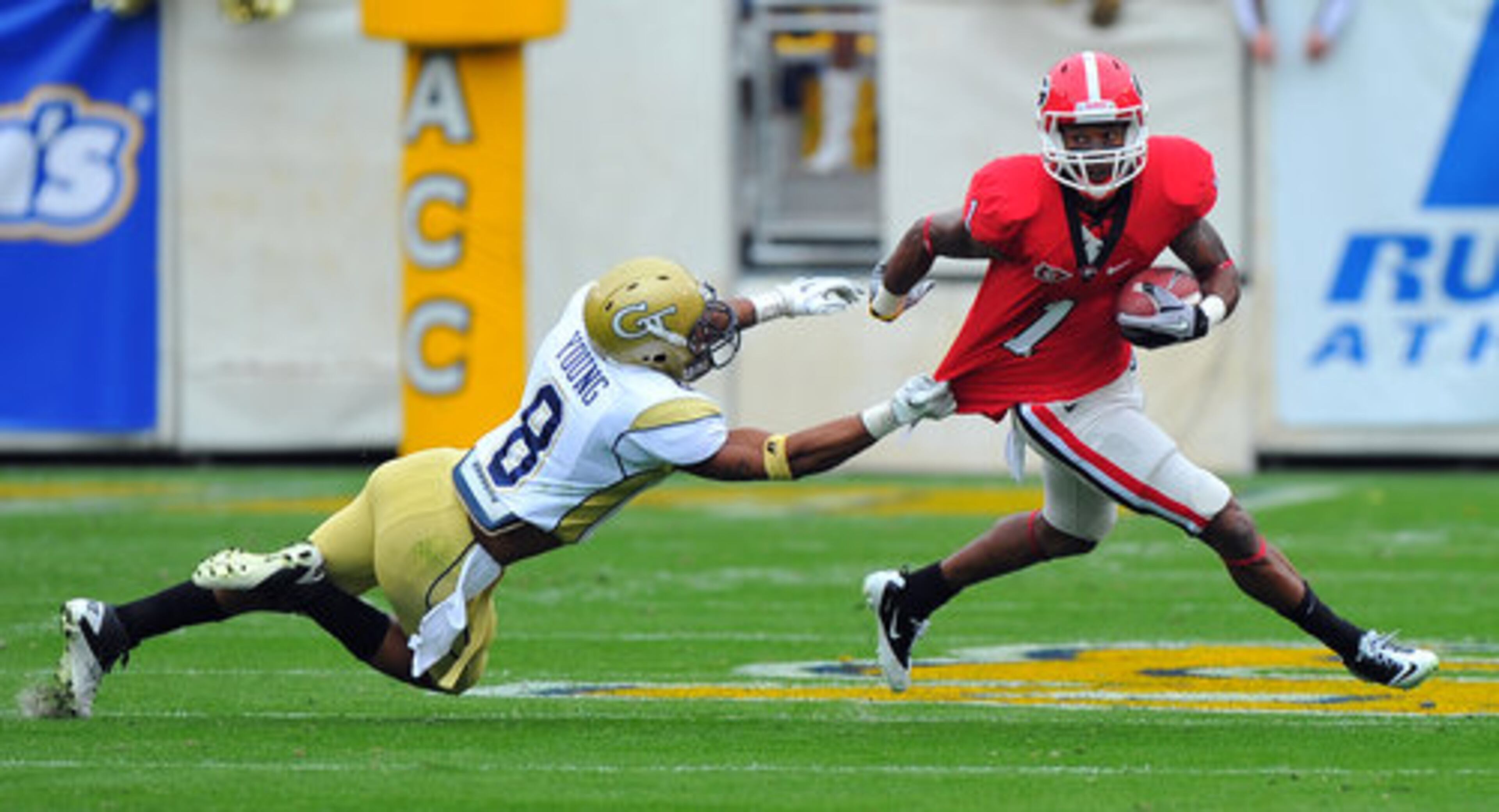 UGA's Branden Smith escapes the grasp of Georgia Tech's Louis Young.