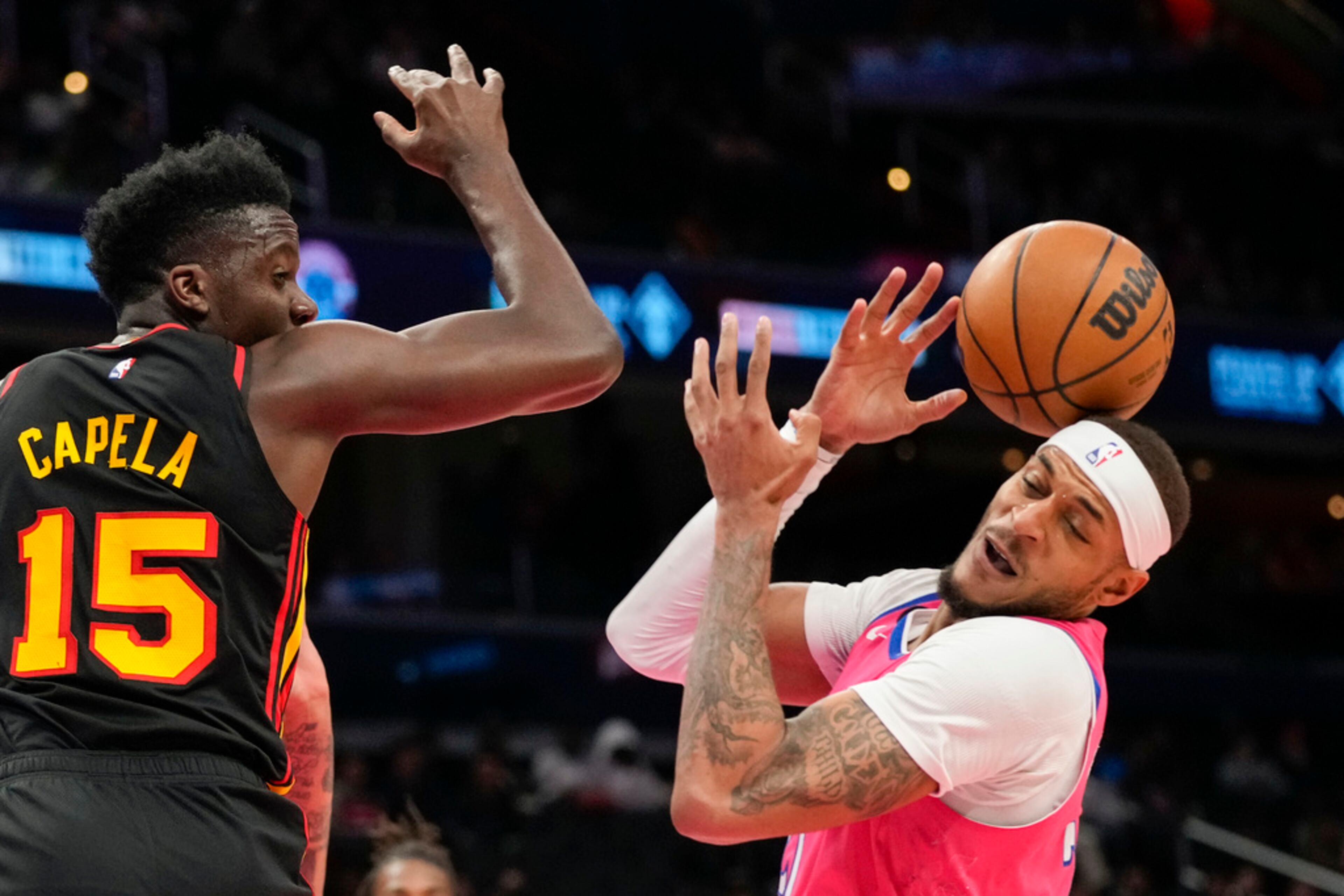Atlanta Hawks center Clint Capela (15) watches as Washington Wizards center Daniel Gafford (21) looses control of the ball during the first half of an NBA basketball game Wednesday, March 8, 2023, in Washington. (AP Photo/Alex Brandon)