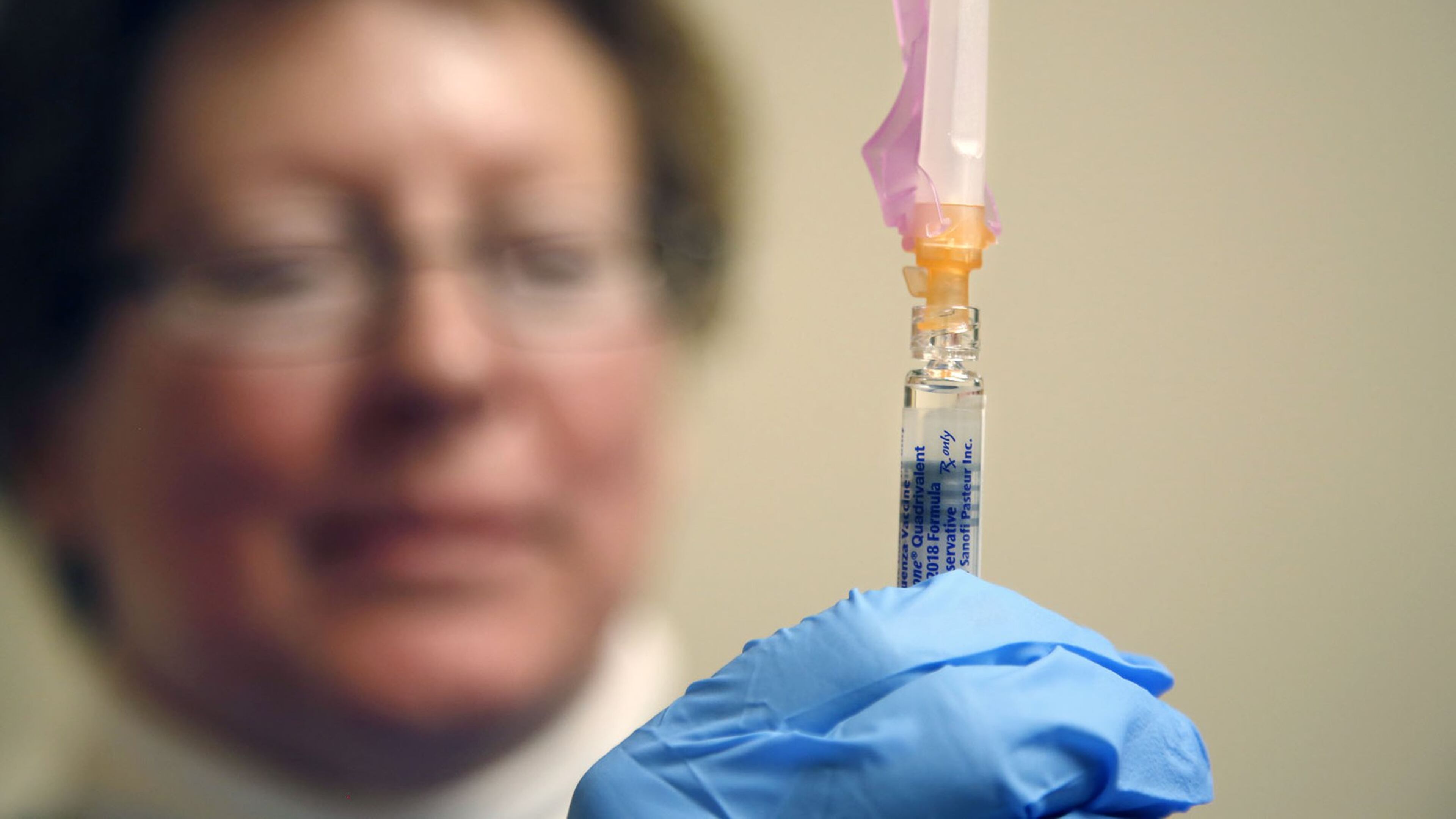 An official with Public Health - Dayton & Montgomery County holds a flu vaccine. KAITLIN SCHROEDER/STAFF