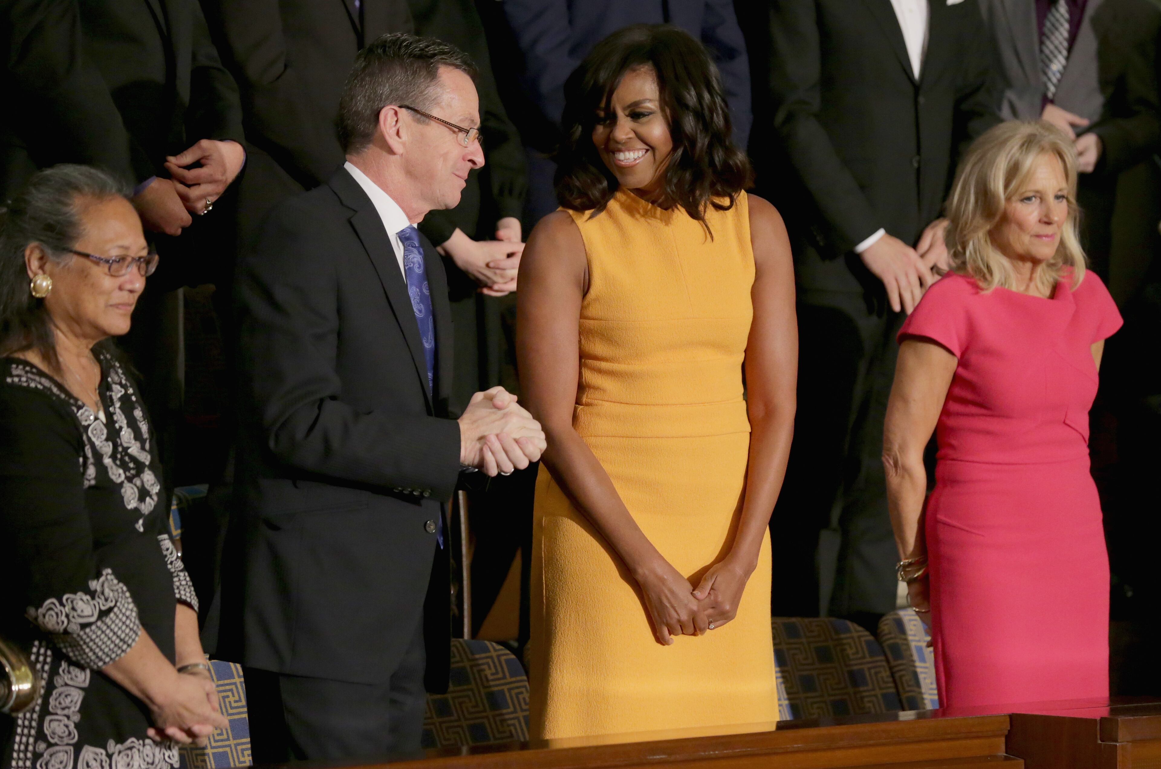 From left, Cynthia K. Davis of Las Vegas, NV., Gov. Dannel P. Malloy of Connecticut, first lady Michelle Obama, and wife of U.S. Vice President Joe Biden, Dr. Jill Biden arrive before US President Barack Obama delivers the State of the Union speech before members of Congress in the House chamber of the U.S. Capitol January 12, 2016 in Washington, DC. (Photo by Chip Somodevilla/Getty Images)