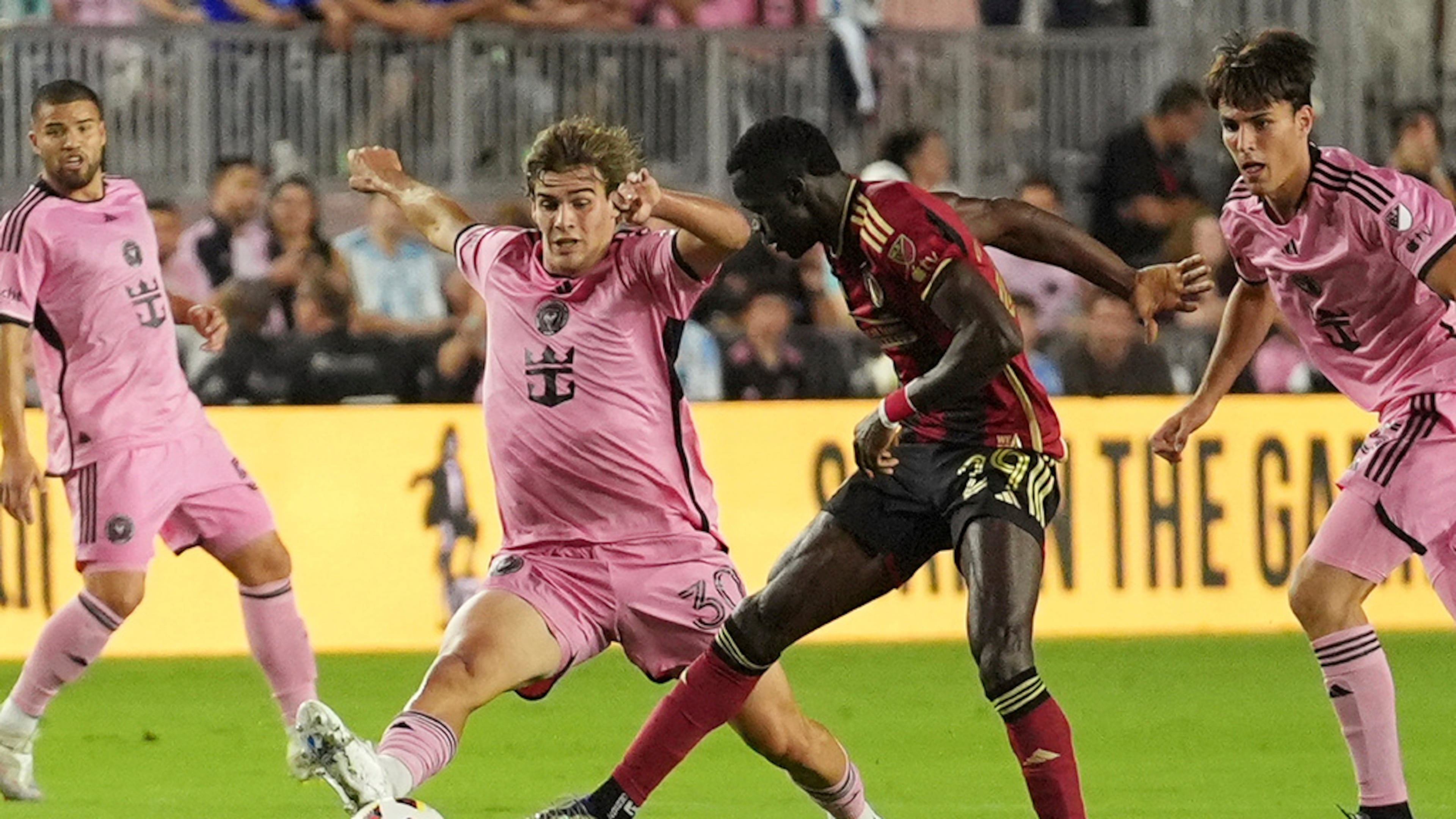 Inter Miami midfielder Benjamin Cremaschi (30) and Atlanta United forward Jamal Thiare (29) go after the ball during the first half of their MLS playoff opening round soccer match, Saturday, Nov. 9, 2024, in Fort Lauderdale, Fla. (AP Photo/Rebecca Blackwell)