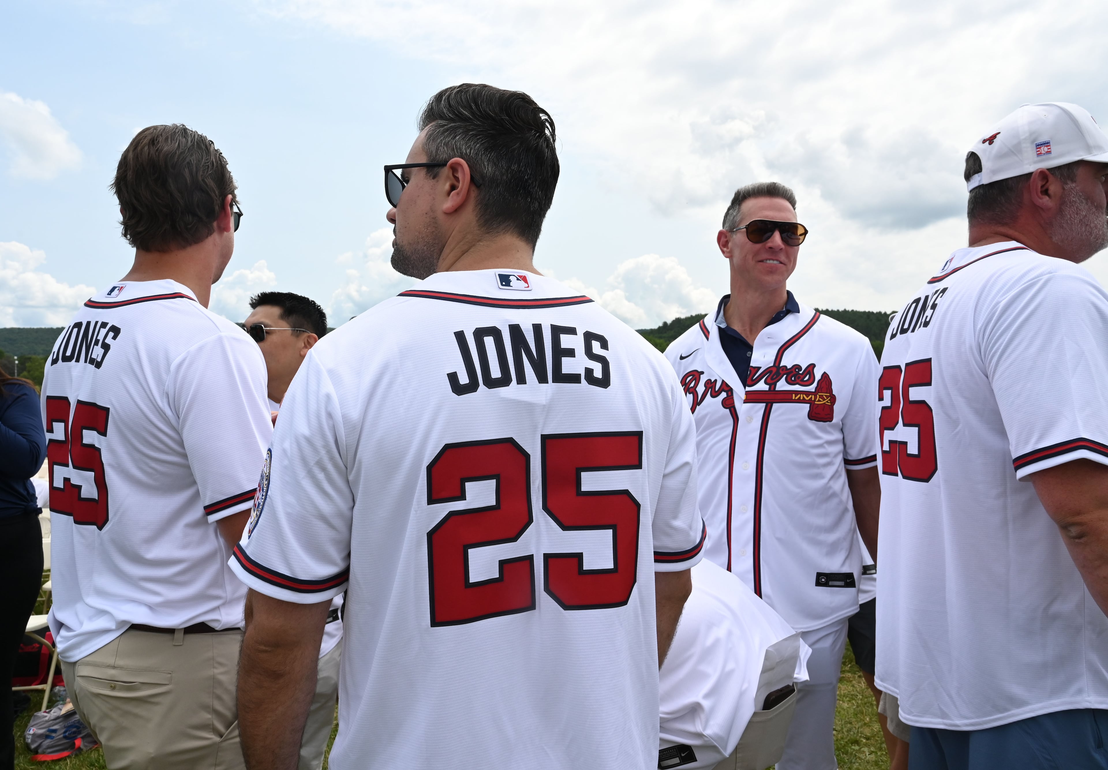Baseball fans wearing Atlanta Braves No. 25 jerseys are seen before the 2026 National Baseball Hall of Fame Induction Ceremony at the Clark Sports Center on Sunday, July 26, 2026, in Cooperstown, N.Y. Braves centerfielder Andruw Jones is set for induction into the National Baseball Hall of Fame as part of the Class of 2026, alongside Carlos Beltrán and Jeff Kent. (Hyosub Shin/AJC)