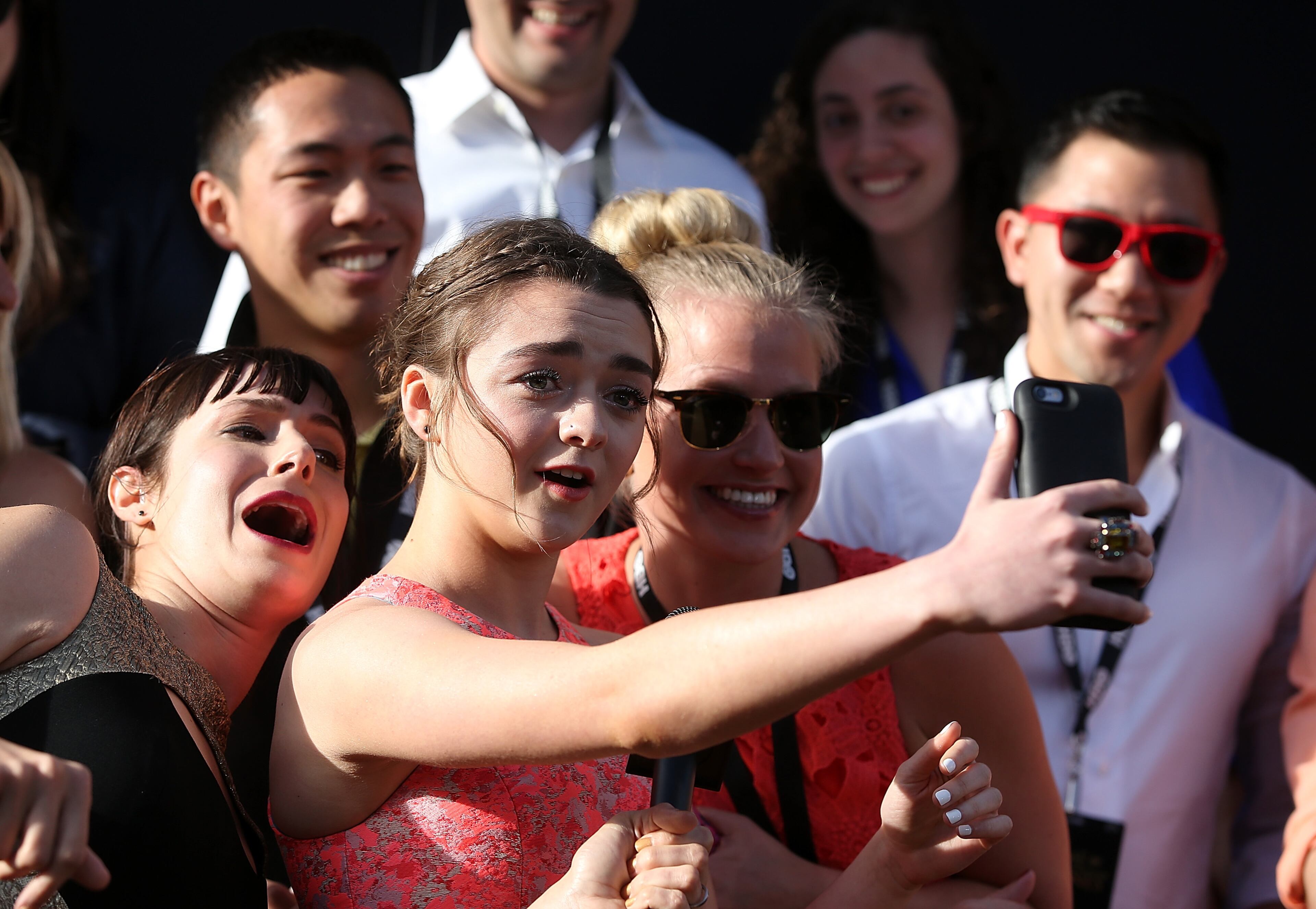 Actress Maisie Williams (C) does a selfie with fans as she attends the premiere of HBO's 'Game of Thrones' Season 5 at San Francisco Opera House on March 23, 2015 in San Francisco, California. (Photo by Justin Sullivan/Getty Images)
