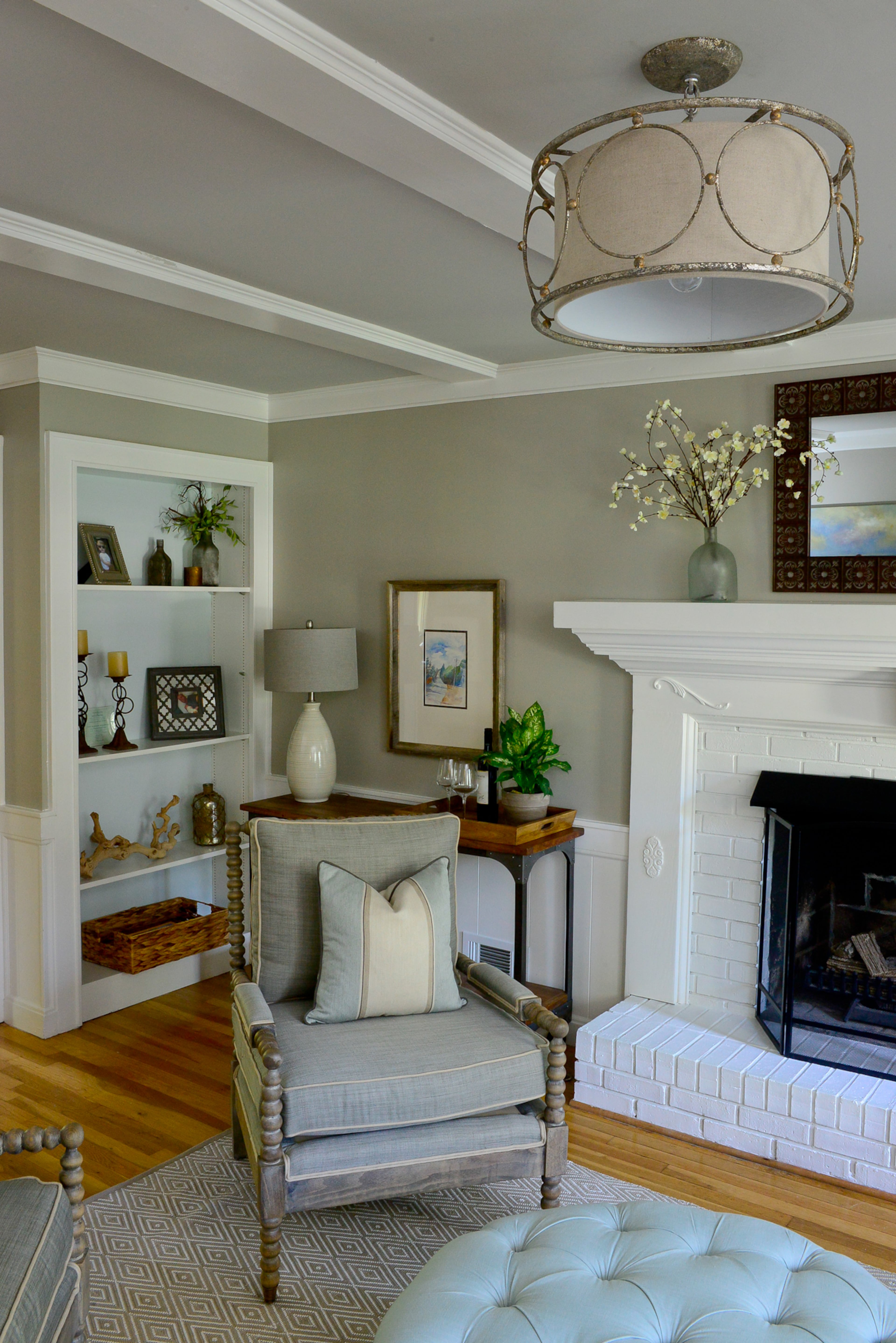 The home oozed with charming features such as built-ins, ceiling details and hardwood floors. The homeowners selected transitional furniture with Southern and rustic elements for the living room.