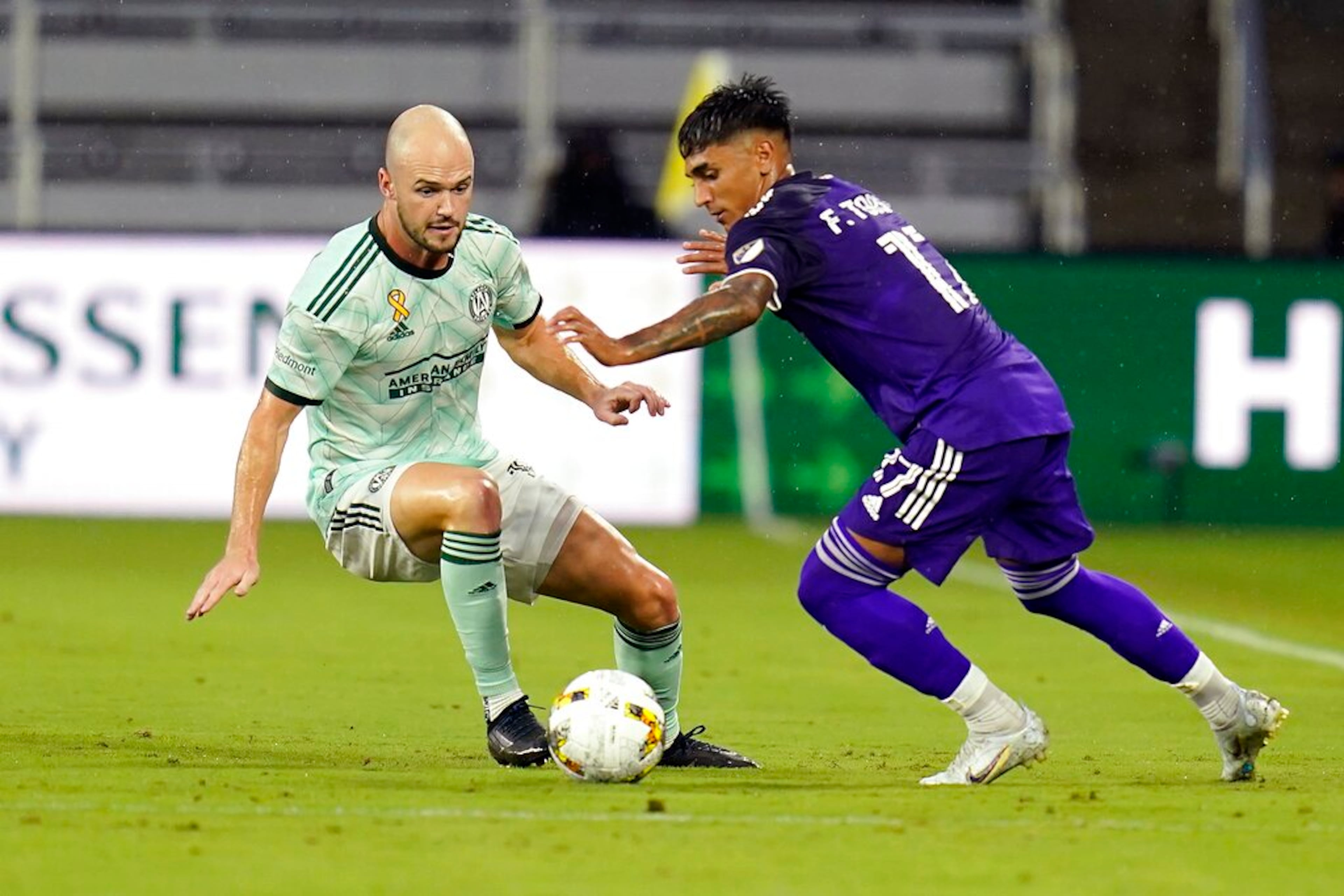 Orlando City's Facundo Torres, right, tries to get around Atlanta United's Andrew Gutman during the first half of an MLS soccer match Wednesday, Sept. 14, 2022, in Orlando, Fla. (AP Photo/John Raoux)