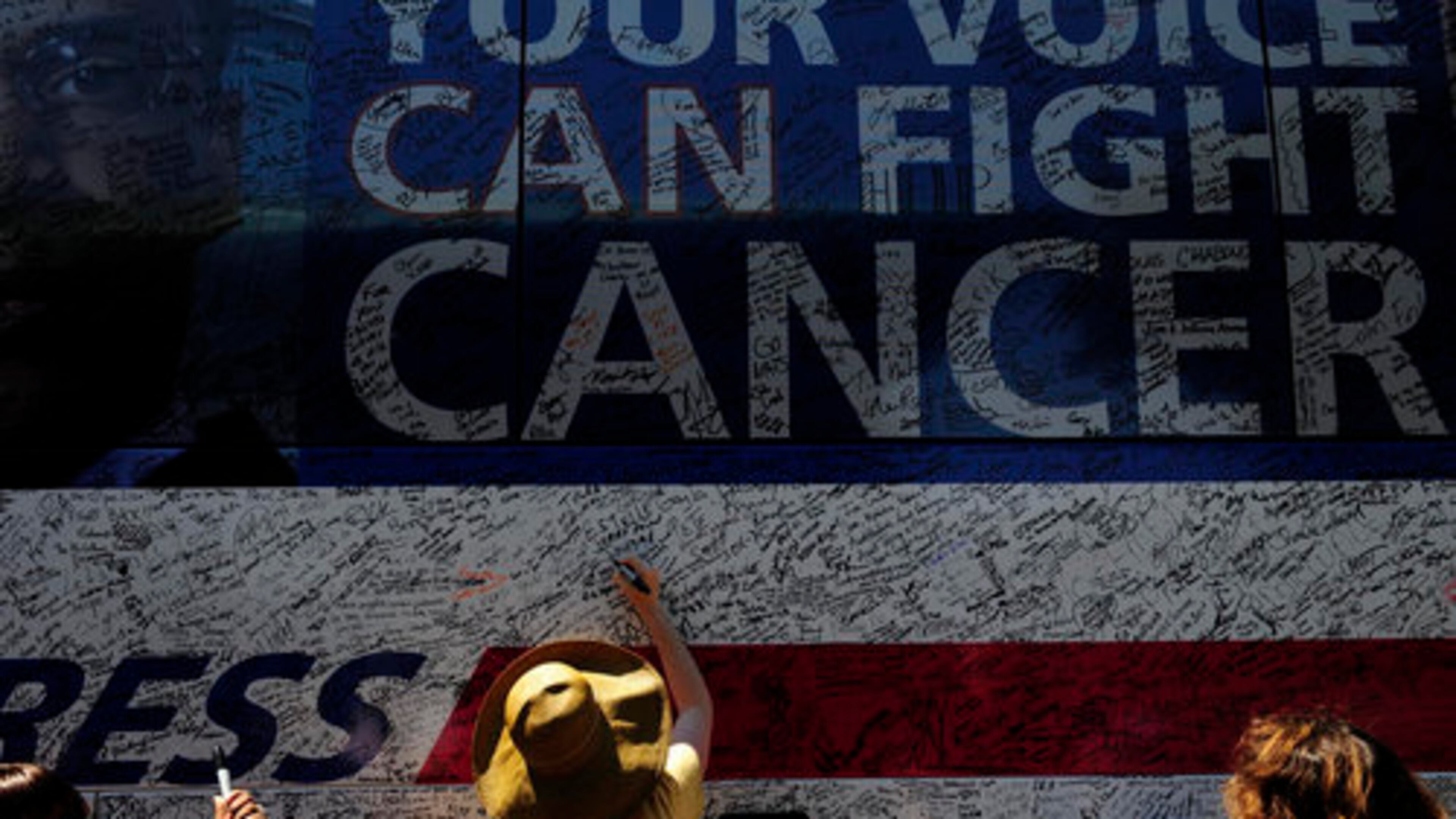 On Wednesday in Atlanta, two-time breast cancer survivor Felicia Kahn Michelson signs the American Cancer Society's Fight Back Express Bus for herself, her mother and her sister, who is currently battling the disease. The American Cancer Society Cancer Action Network (ASC CAN) is sponsoring a six-month nationwide bus tour that will travel the country for cancer awareness.