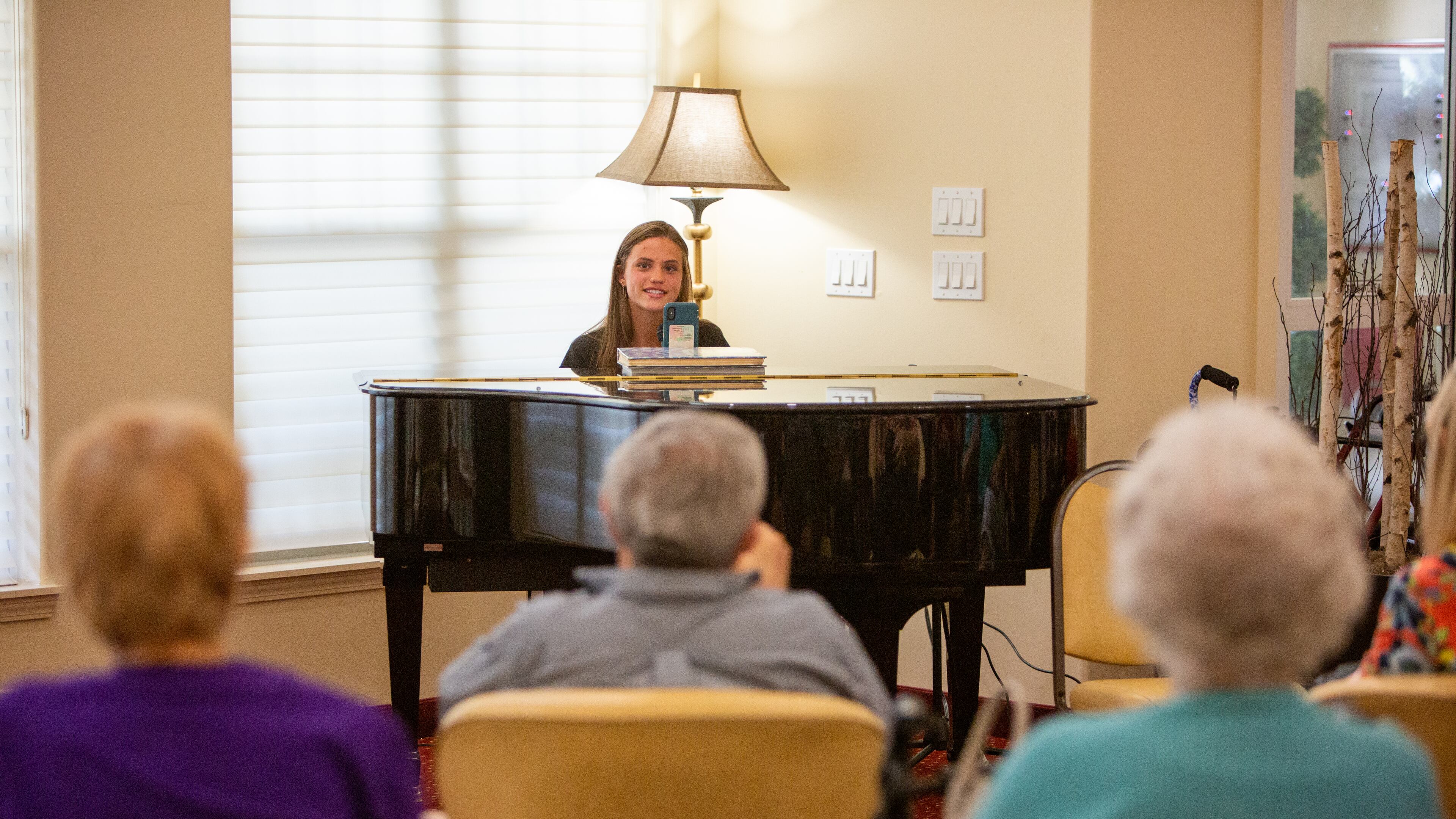 Kate Lauterbach sings and interacts with residents at Sanford Estates in Roswell. The 17-year-old Marist student has a passion for singing and is channeling it into a day-brightener for seniors. PHIL SKINNER FOR THE ATLANTA JOURNAL-CONSTITUTION.