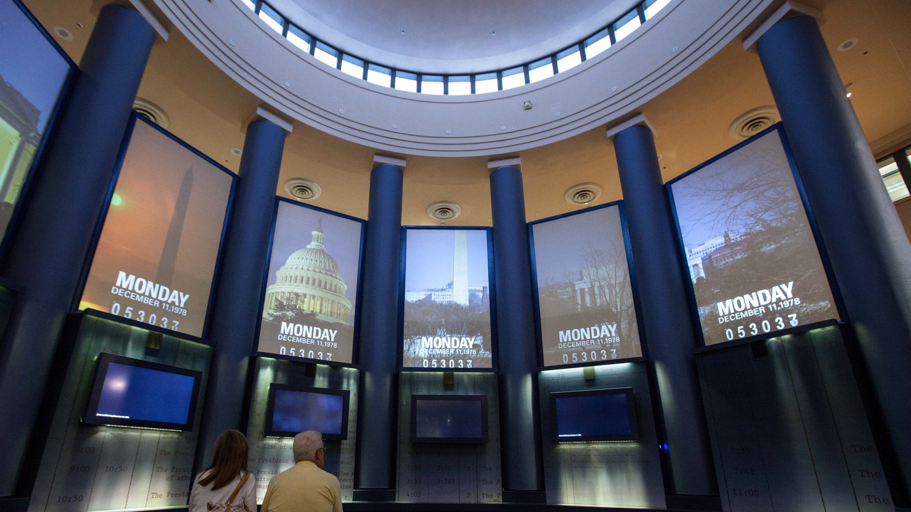 FILE ART: A couple watches a video inside the museum at the Carter Presidential Library in Atlanta on Aug. 15, 2015. BRANDEN CAMP / SPECIAL