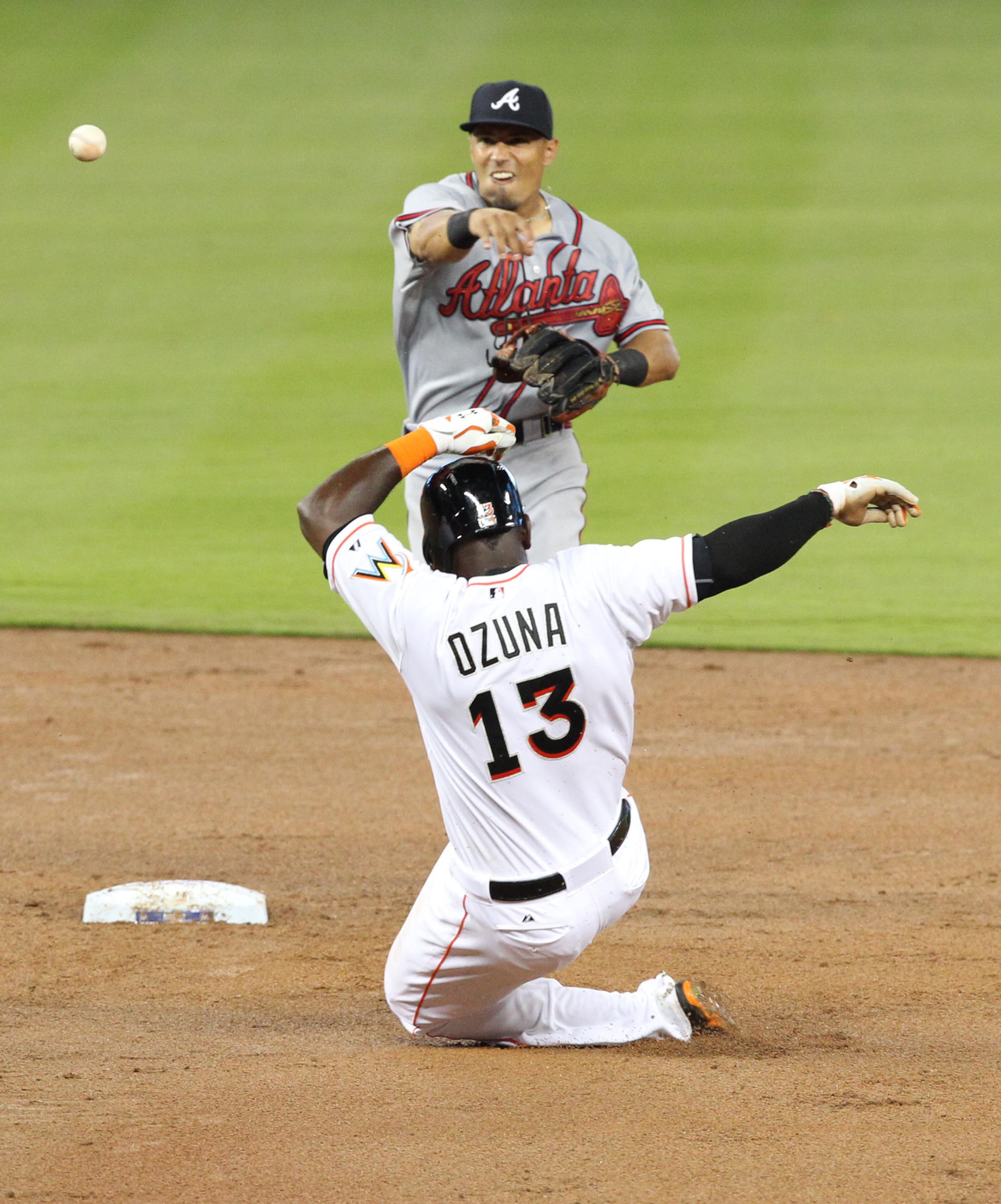 Miami Marlins' Marcell Ozuna is tagged out at second base by Atlanta Braves' Andrelton Simmons during the fifth inning on Monday, April 6, 2015, at Marlins Park in Miami. (Hector Gabino/El Nuevo Herald/TNS)