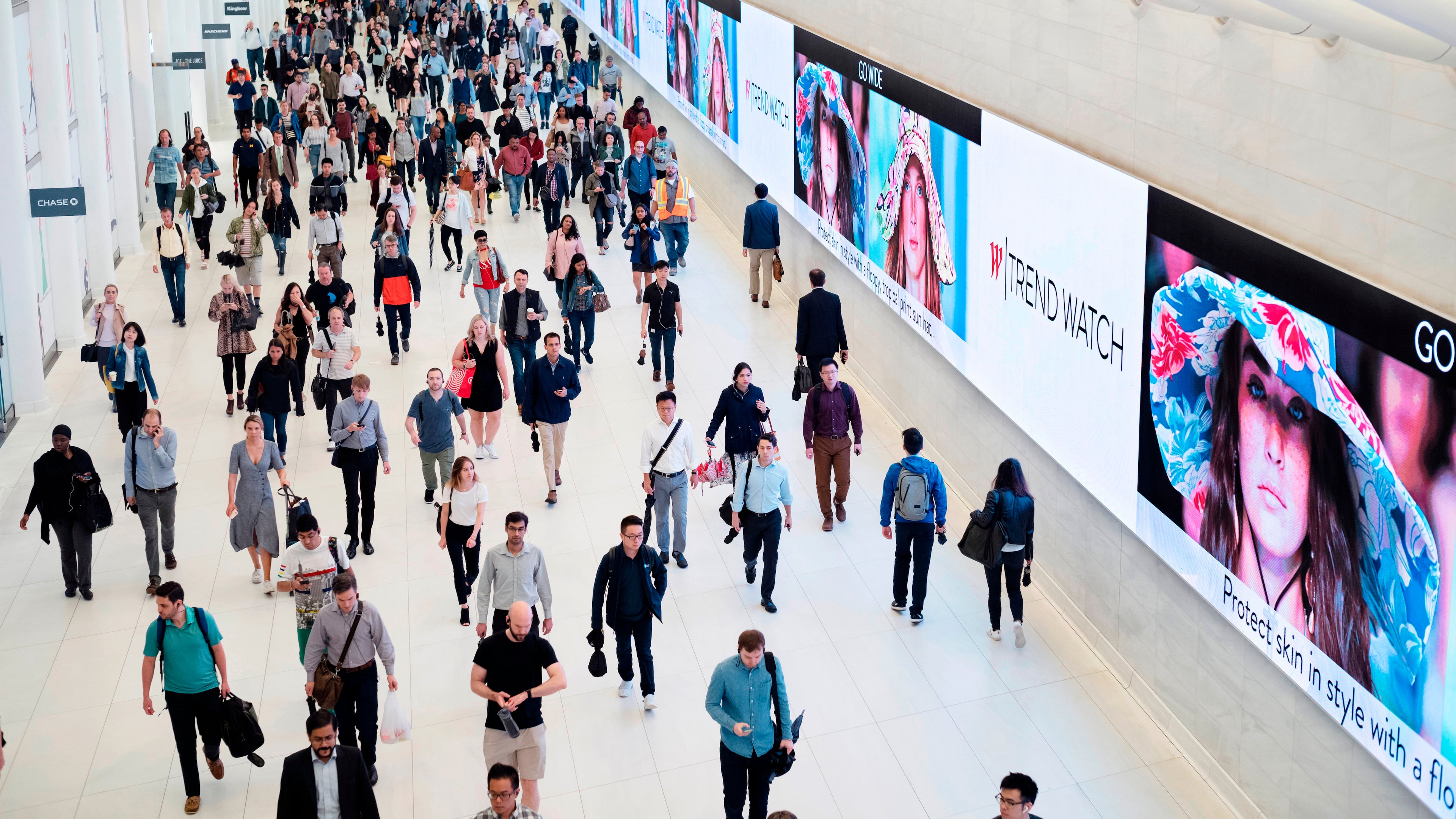 FILE - Commuters walk through a corridor in the World Trade Center Transportation Hub in New York on June 21, 2019. (AP Photo/Mark Lennihan, File)