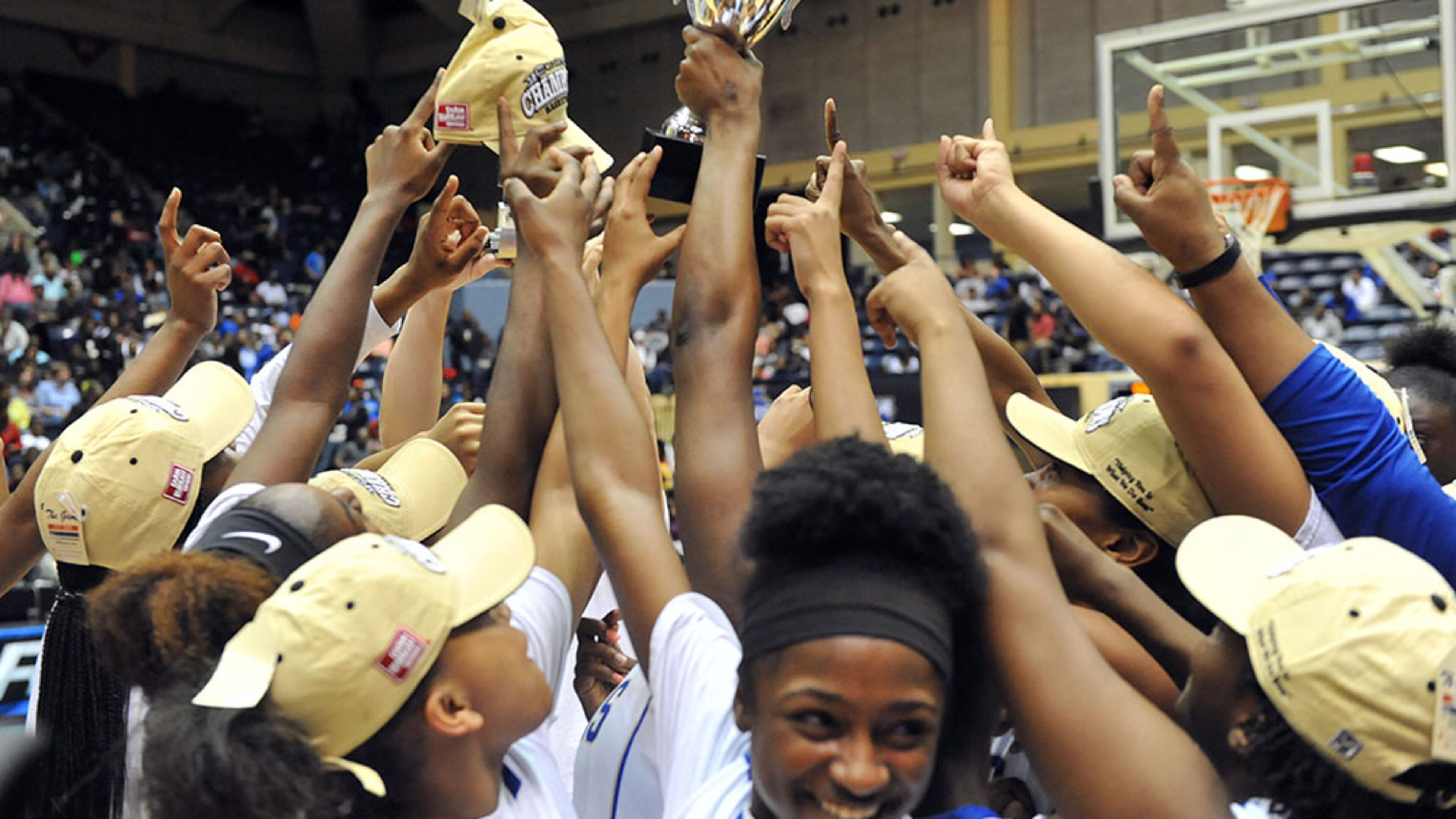 MARCH 7, 2015 MACON McEachern Indians players celebrate with the championship trophy. Coverage of Class AAAAAA girls state championship game between the McEachern Indians and the Norcross Blue Devils in the Georgia High School Basketball championships at the Macon Coliseum, Saturday, March 7, 2015. Norcross led 32-25 at the half. The McEachern Indians beat Norcross, 58-51 in overtime. KENT D. JOHNSON/KDJOHNSON@AJC.COM McEachern Indians players celebrate with the Class AAAAAA girls championship trophy. (Kent D. Johnson / AJC)