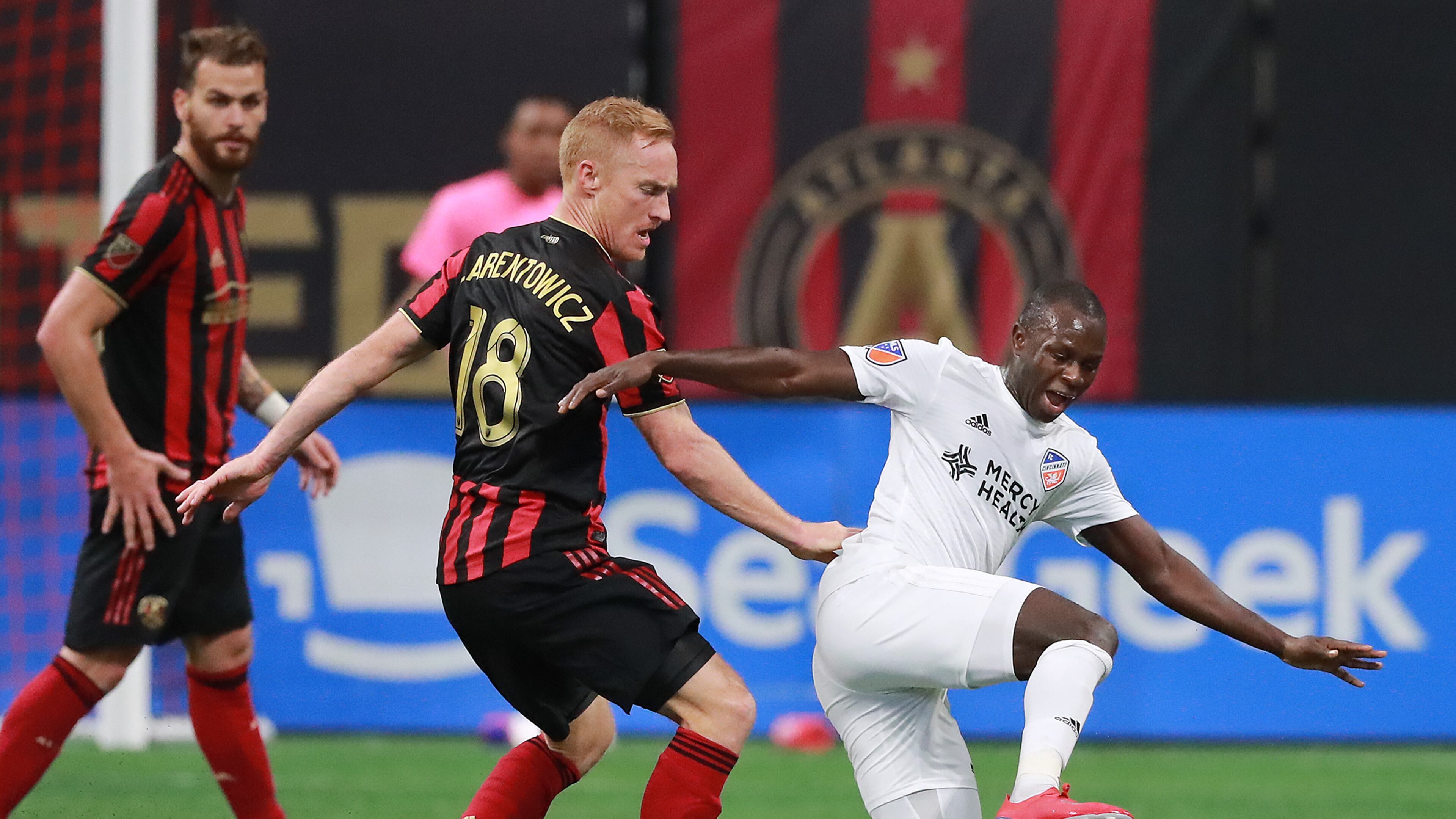 March 10, 2019 Atlanta: Atlanta United midfielder Jeff Larentowicz knocks FC Cincinnati forward Kekuta Manneh to the turf during the first half in their MLS soccer match on Sunday, March 10, 2019, in Atlanta. Curtis Compton/ccompton@ajc.com
