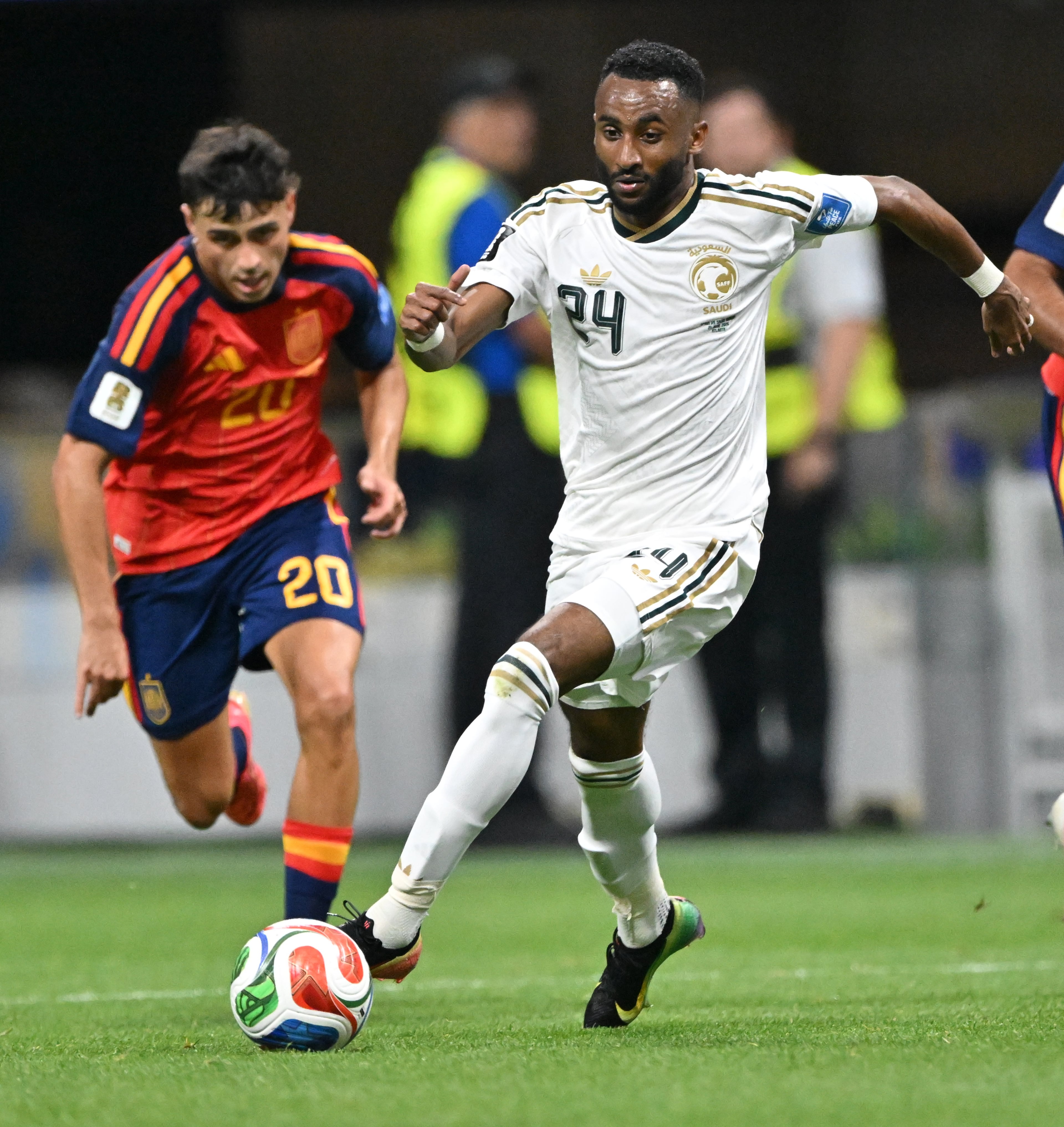 Saudi Arabia's Moteb Al-Harbi (center) moves the ball forward as Spain's Pedri follows during the first half of the Spain vs. Saudi Arabia World Cup match Sunday, June 21, 2026, at Atlanta Stadium. (Hyosub Shin/AJC)