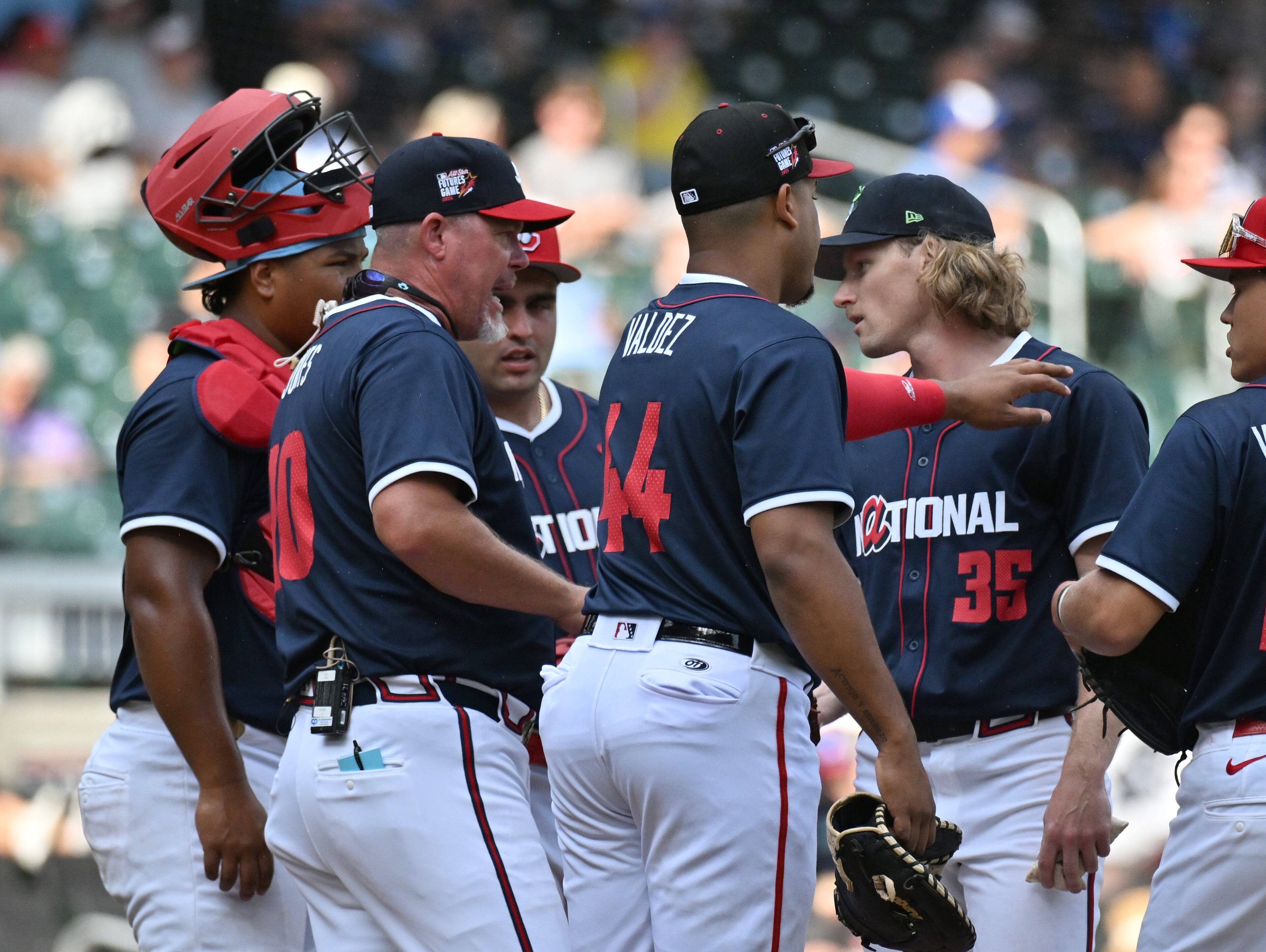 National League manager Chipper Jones confers with National League pitcher Hayden Harris (35) during the fourth inning of the All-Star Futures Game at Truist Park, Saturday, July 12, 2025, in Atlanta. National League won 4-2 over American League. (Hyosub Shin / AJC)
