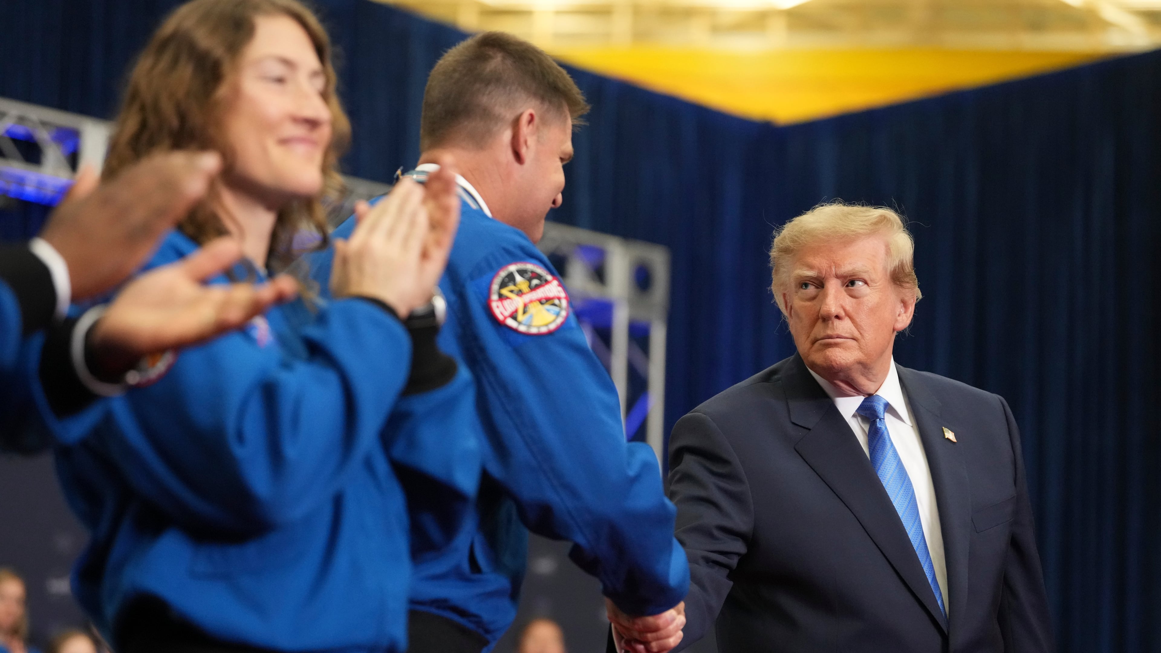 President Donald Trump, from right, shakes the hand of Artemis II crew member Jeremy Hansen after presenting him the Congressional Space Medal of Honor as fellow recipient Christina Koch applauds, Friday, Aug. 28, 2026, at Johnson Space Center in Houston. (AP Photo/Mark Schiefelbein)