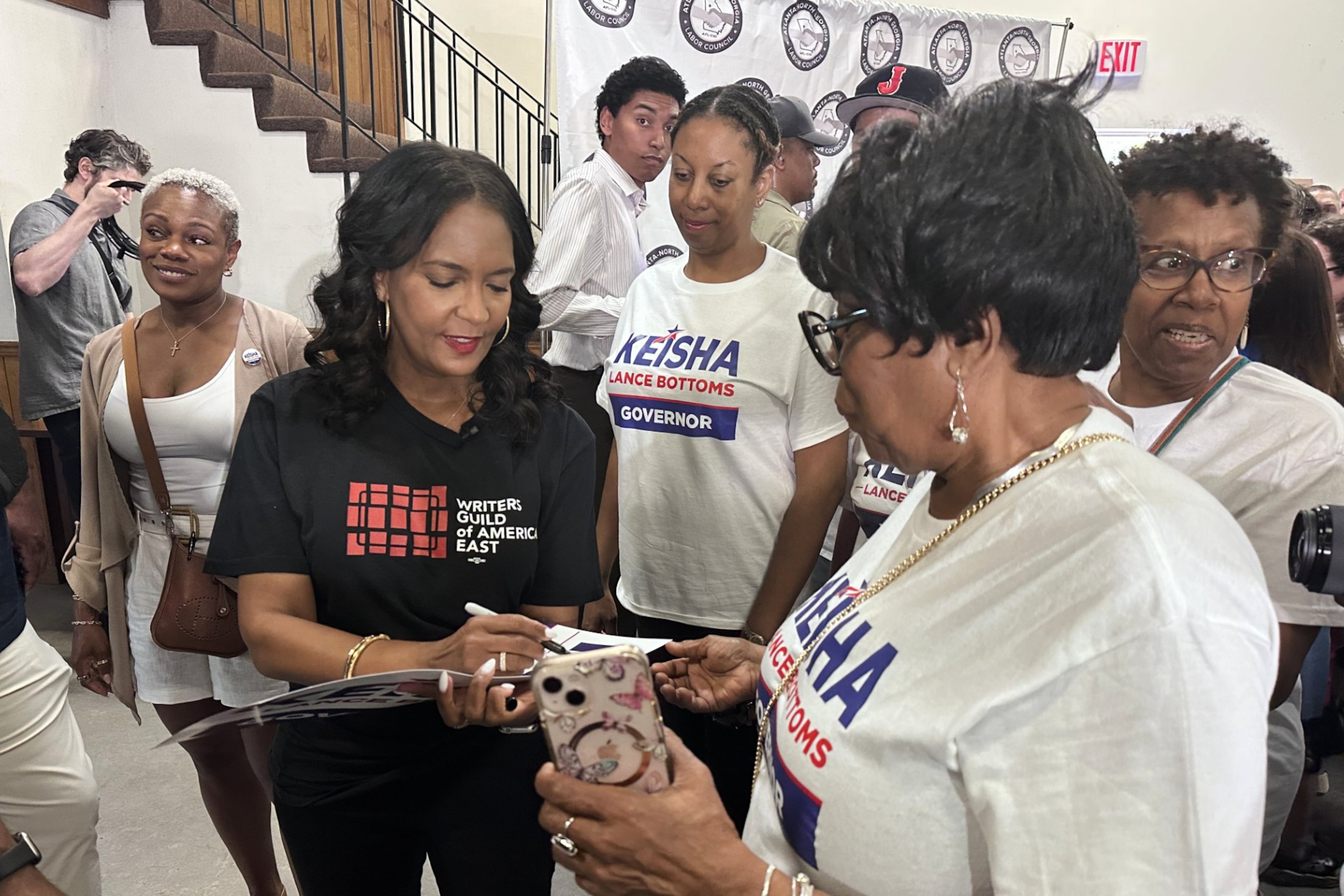 Democratic nominee for governor Keisha Lance Bottoms signs a campaign sign for a supporter during an Atlanta-North Georgia Labor Council Labor Day lunch in Hapeville on Monday. (Bill Barrow/AP)
