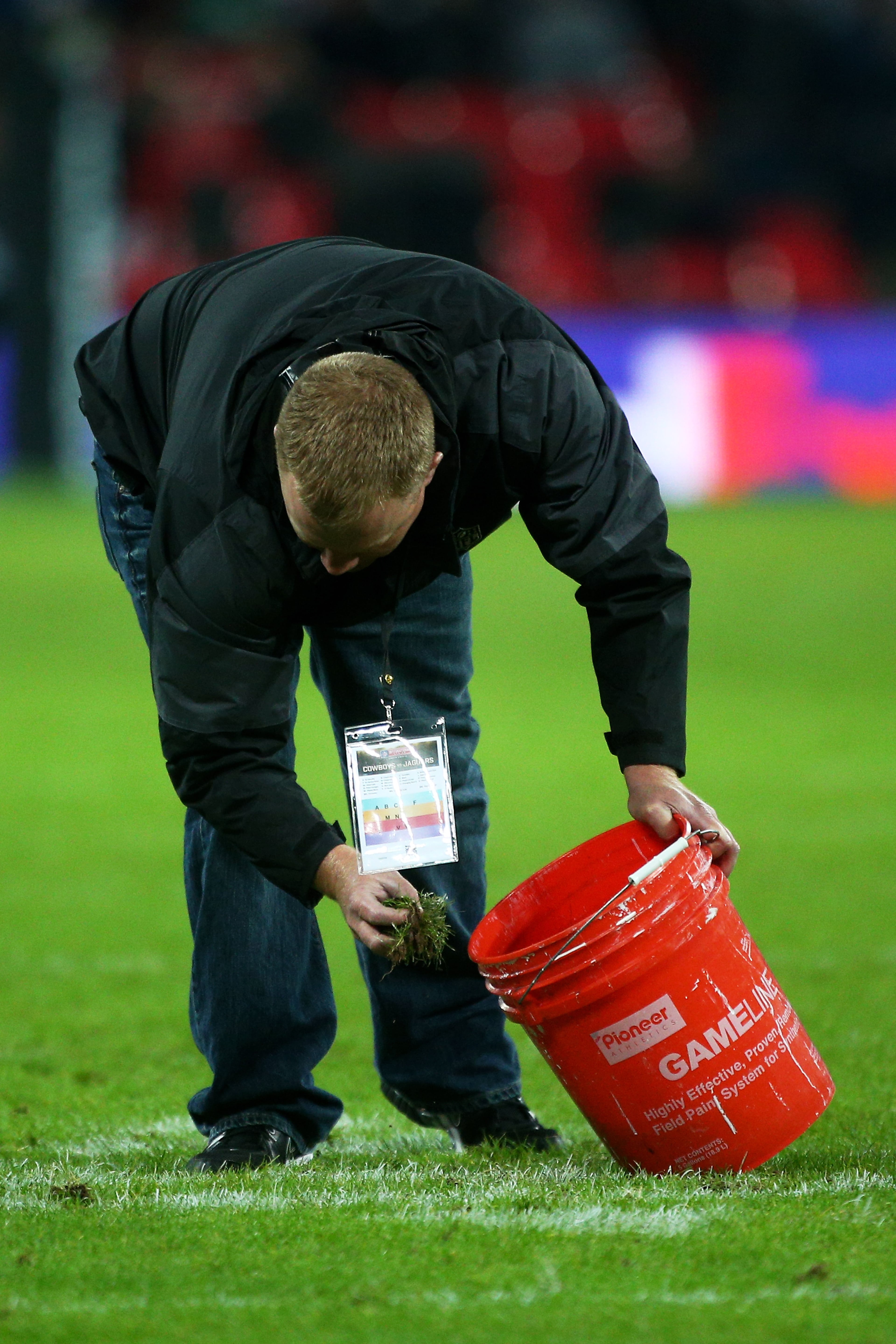 LONDON, ENGLAND - NOVEMBER 09: Groundstaff remove divots from the pitch at halftime during the NFL week 10 match between the Jackson Jaguars and the Dallas Cowboys at Wembley Stadium on November 9, 2014 in London, England. (Photo by Charlie Crowhurst/Getty Images)