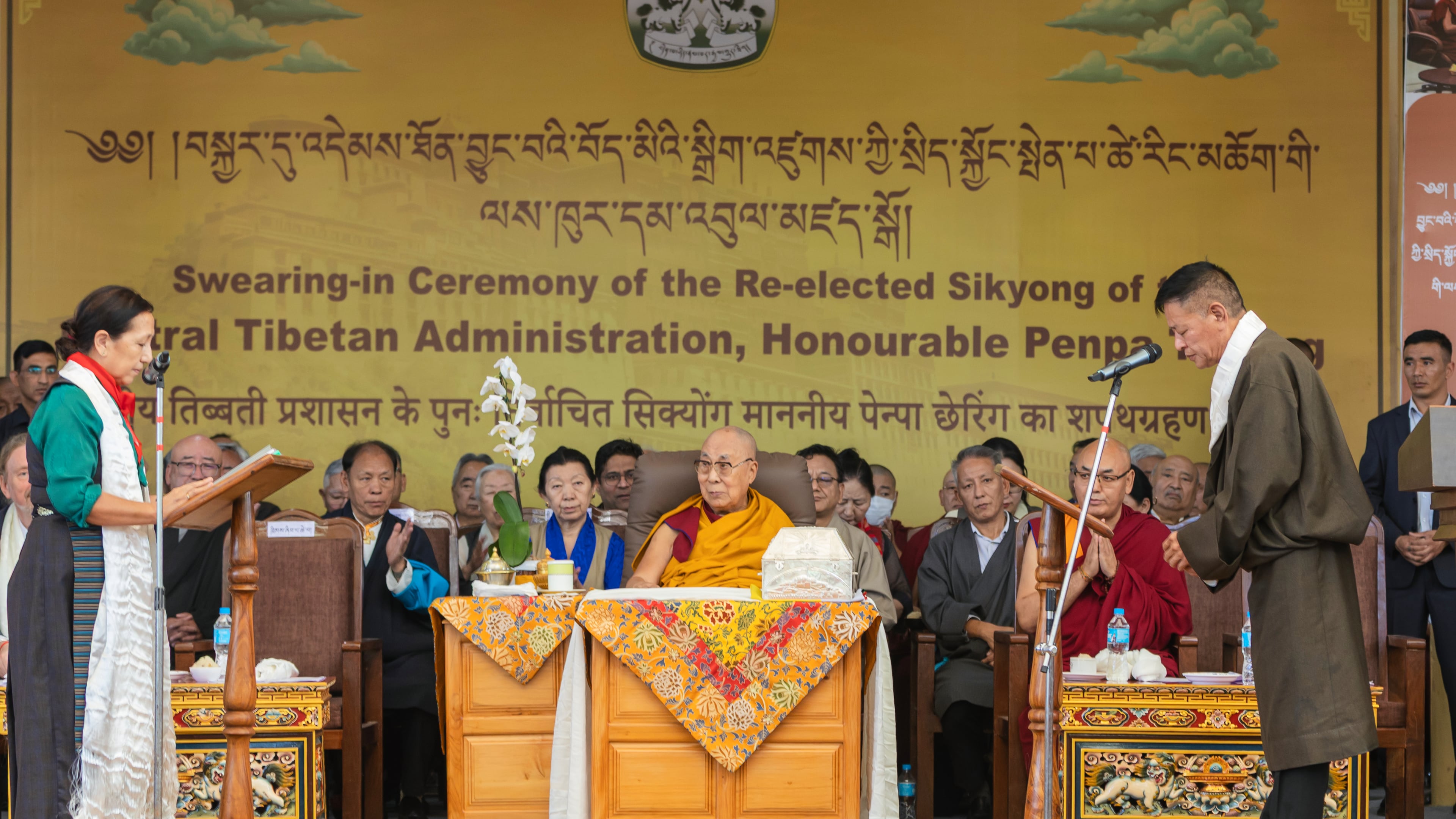 Chief Justice Commissioner of the Tibetan Supreme Justice Commission, Yeshi Wangmo, left, administers the oath of office to Penpa Tsering, right, as the political leader of Tibet's government-in-exile, in the presence of Tibetan spiritual leader the Dalai Lama, center, in Dharamshala, India, Wednesday, May 27, 2026. (AP Photo/ Shailesh Bhatnagar)