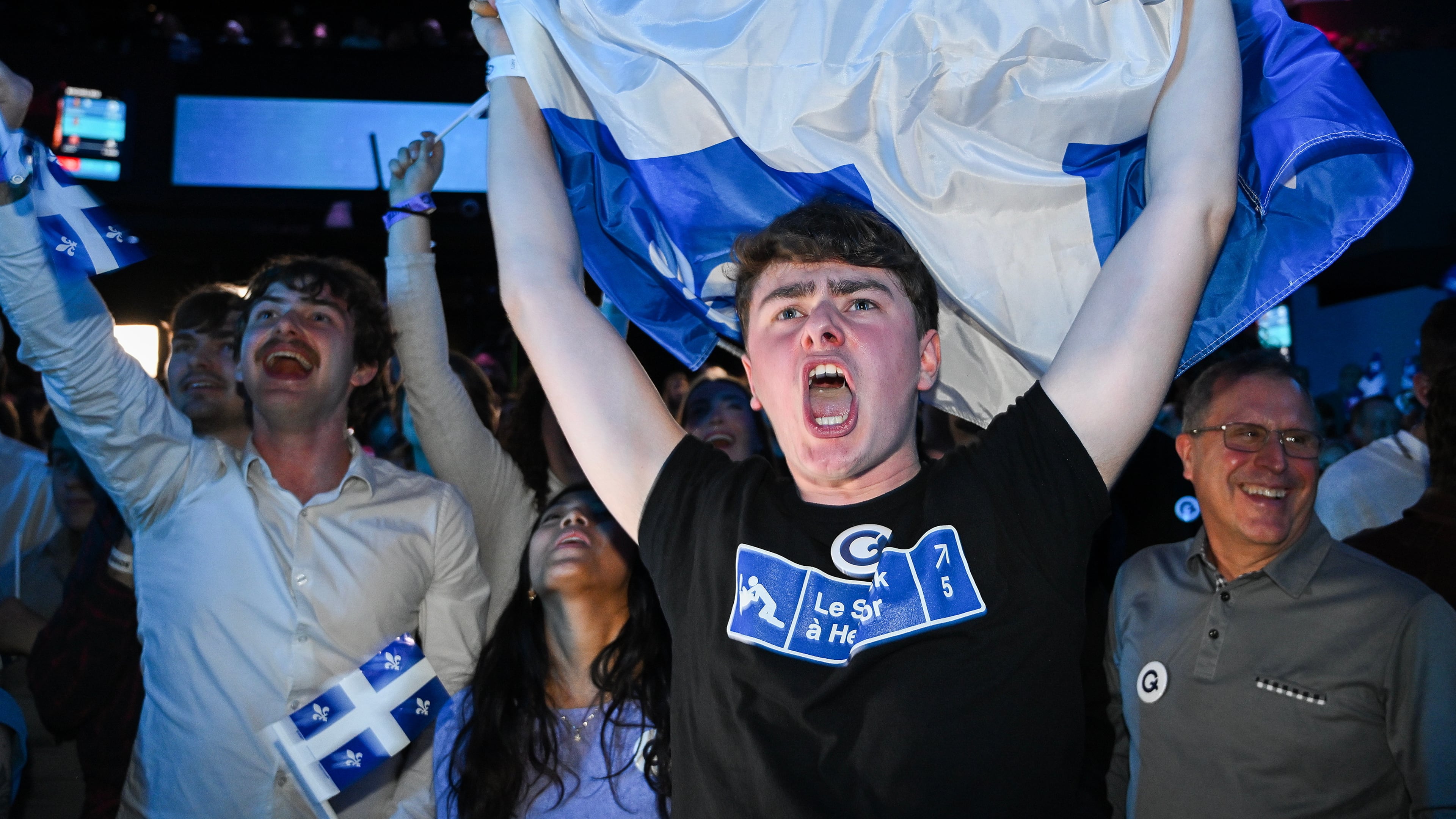 Parti Quebecois supporters cheer as results come in at PQ headquarters on election night in Montreal, Quebec on Monday, Oct. 5, 2026. (Graham Hughes/The Canadian Press via AP)