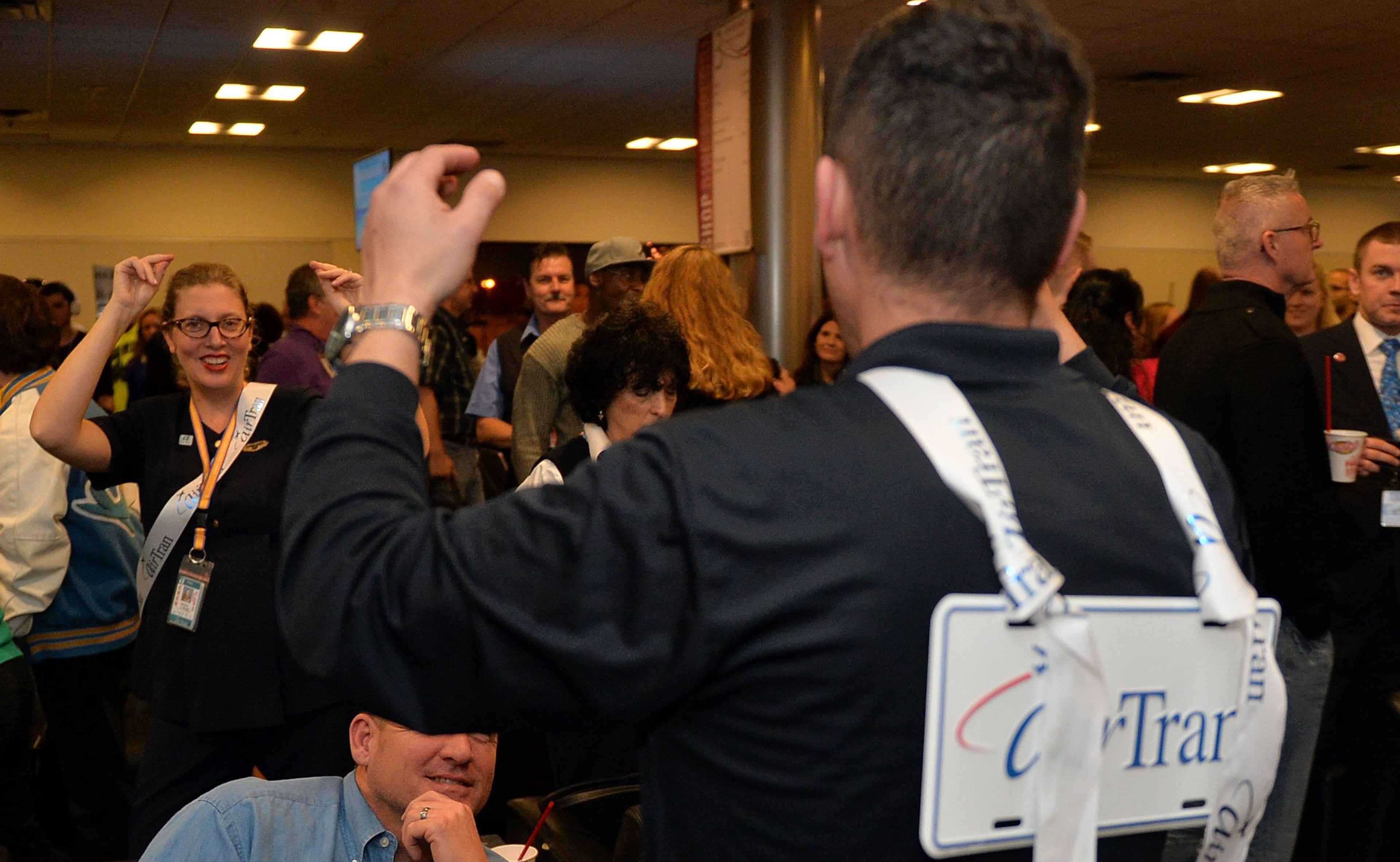 Flight attendants Sarah Wilson and Trebor McDowell dance during the party. Hundreds of Southwest Airlines and former AirTran Airways employees gathered at Concourse C, gates 1, 2 and 3 to celebrate the departure of AirTran’s final flight to Tampa, at Hartsfield-Jackson International Airport, Sunday, December 28, 2014. Southwest CEO Gary Kelly and executives Bob Jordan and Jack Smith gave remarks during the program. The full flight was waved off by employees that gathered on the tarmac as crash trucks from Atlanta Fire Rescue gave a final water cannon salute as the plane departed. KENT D. JOHNSON/KDJOHNSON@AJC.COM