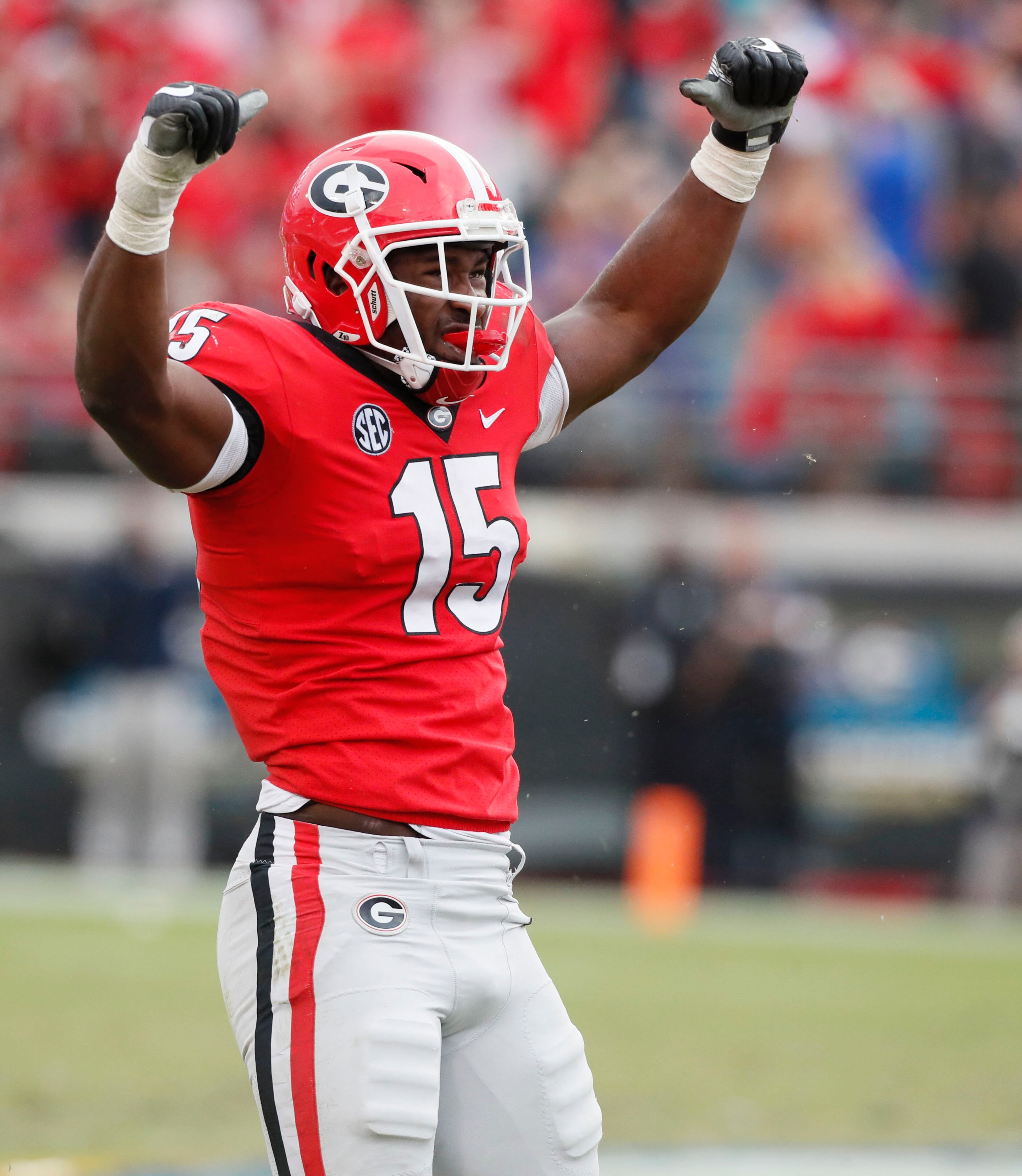 10/27/18 - Jacksonville - Georgia Bulldogs linebacker D'Andre Walker (15) celebrates after he tackled Florida Gators running back Lamical Perine (22) for no gain in the second half. The University of Georgia Bulldogs beat the Florida Gators 36-17 in a NCAA college football game Saturday, Oct. 27th, 2018, at TIAA Bank Field in Jacksonville, FL. BOB ANDRES / BANDRES@AJC.COM