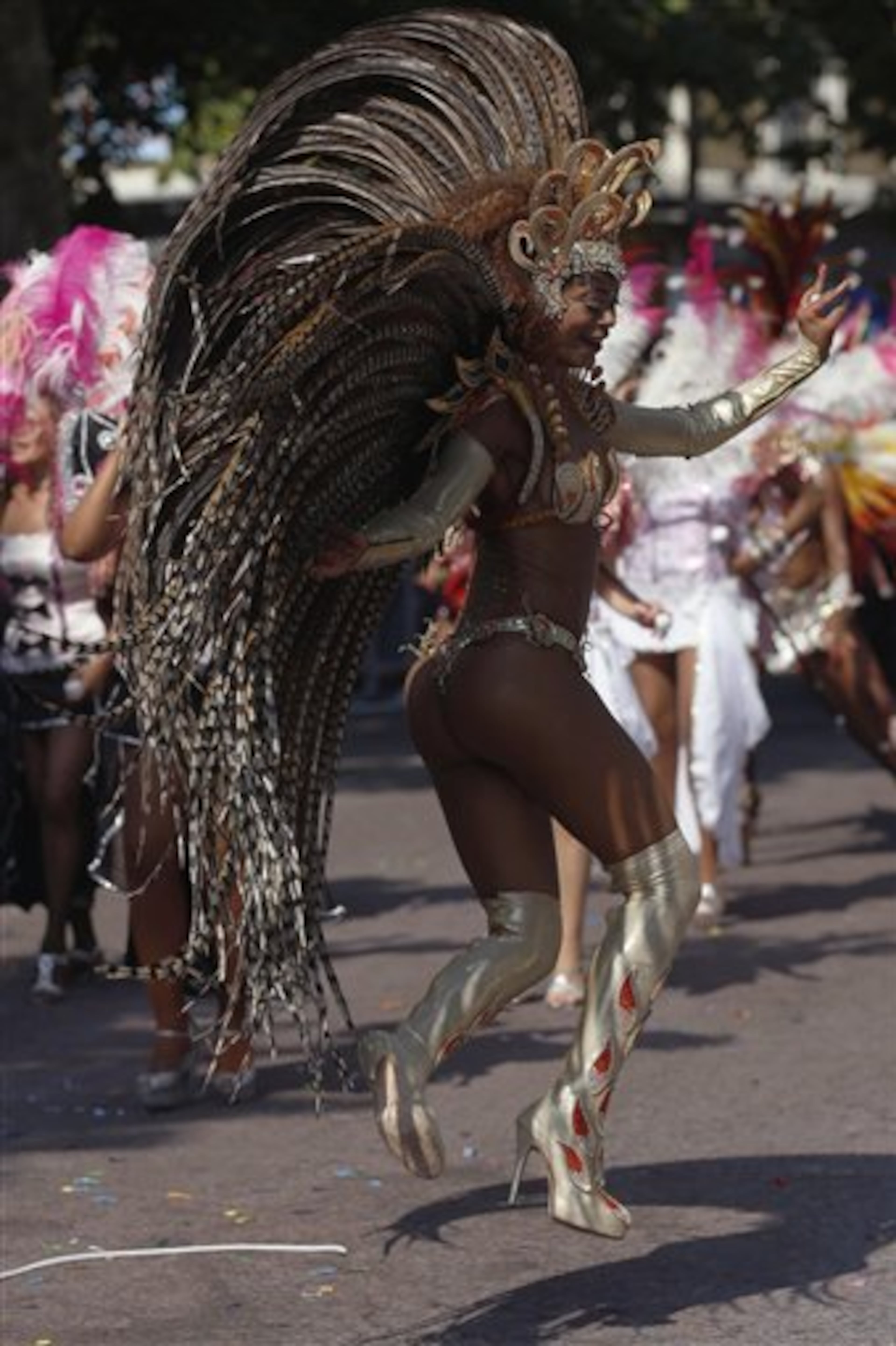 A woman dances as part of a parade, during the Notting Hill Carnival in London, Monday, Aug. 26, 2013. The Notting Hill Carnival is the largest festival celebration of its kind in Europe. (AP Photo/Sang Tan)