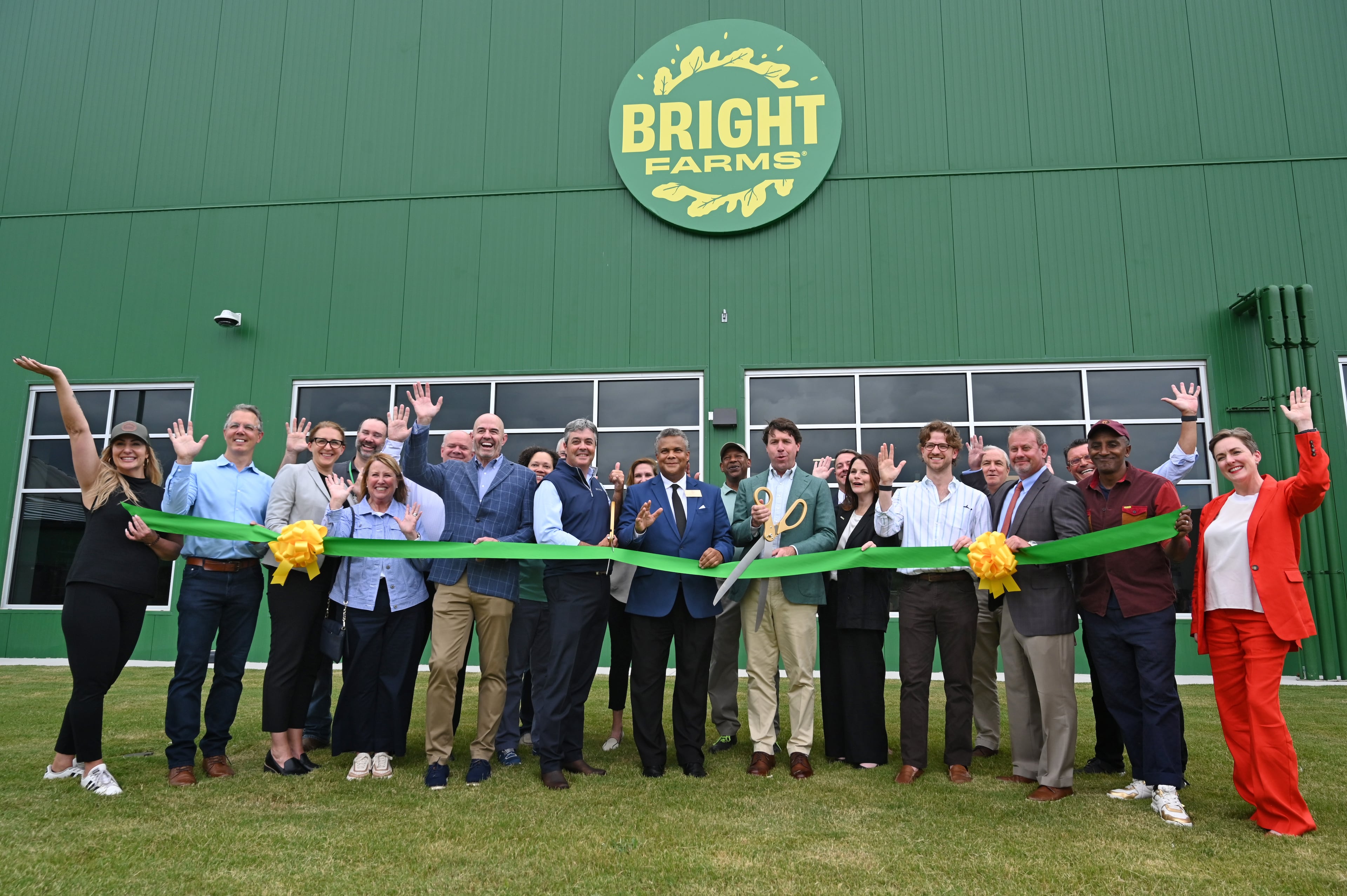 Cox Enterprises Chairman and CEO Alex Taylor (with scissors) and guestscut the ceremonial ribbon during the grand opening of BrightFarms' greenhouse in Macon. (Hyosub Shin/AJC)