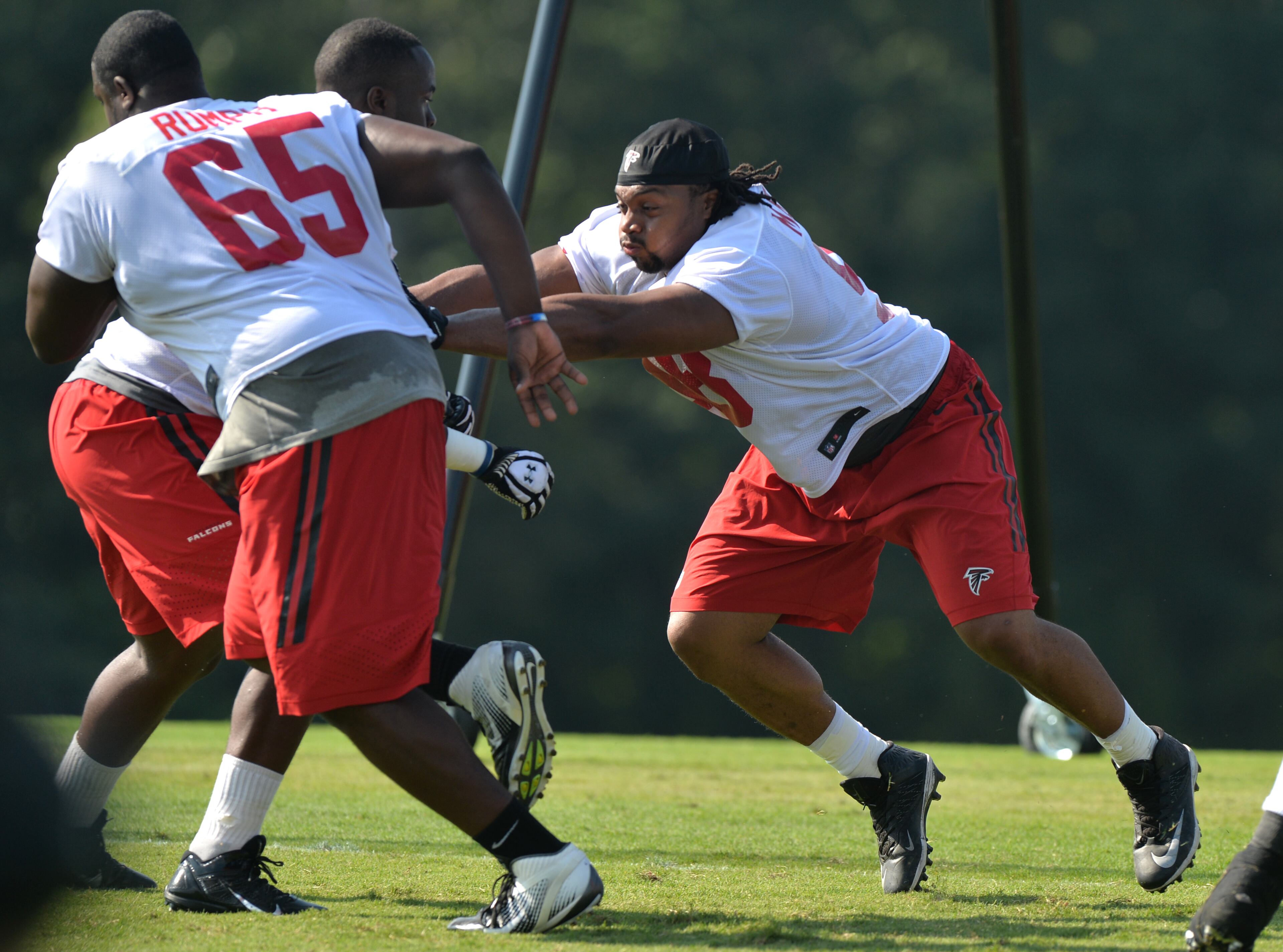 Atlanta Falcons defensive end Cliff Matthews participates in drills during training camp on Friday, July 25, 2014.