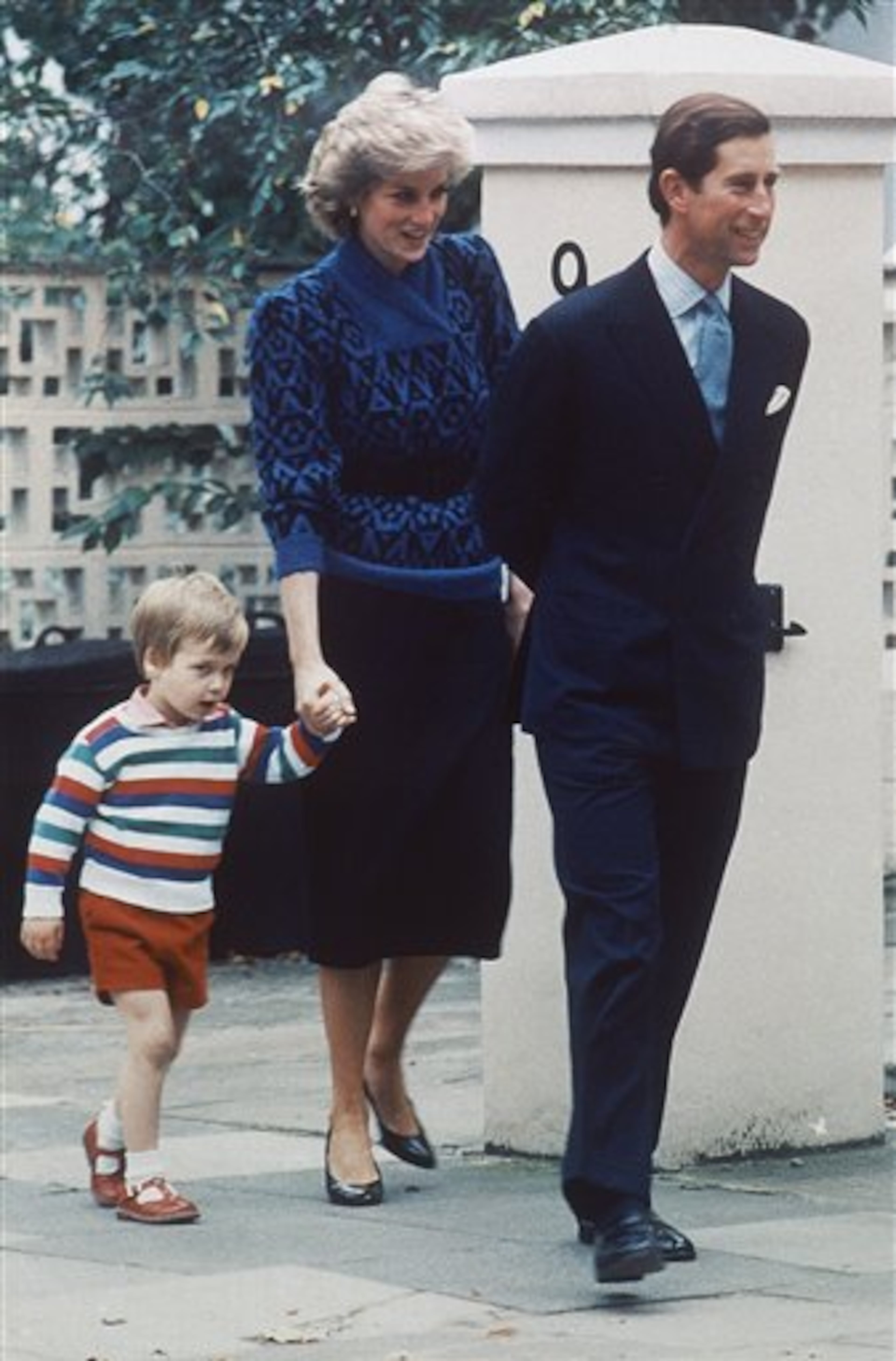 Britain's Prince William, aged 3-year-old, is escorted by his parents Princess Diana and Prince Charles as he arrives at a private kindergarten in London's Notting Hill on Sept. 24, 1985, to start his pre-school education. (AP Photo/Joseph Schaber)