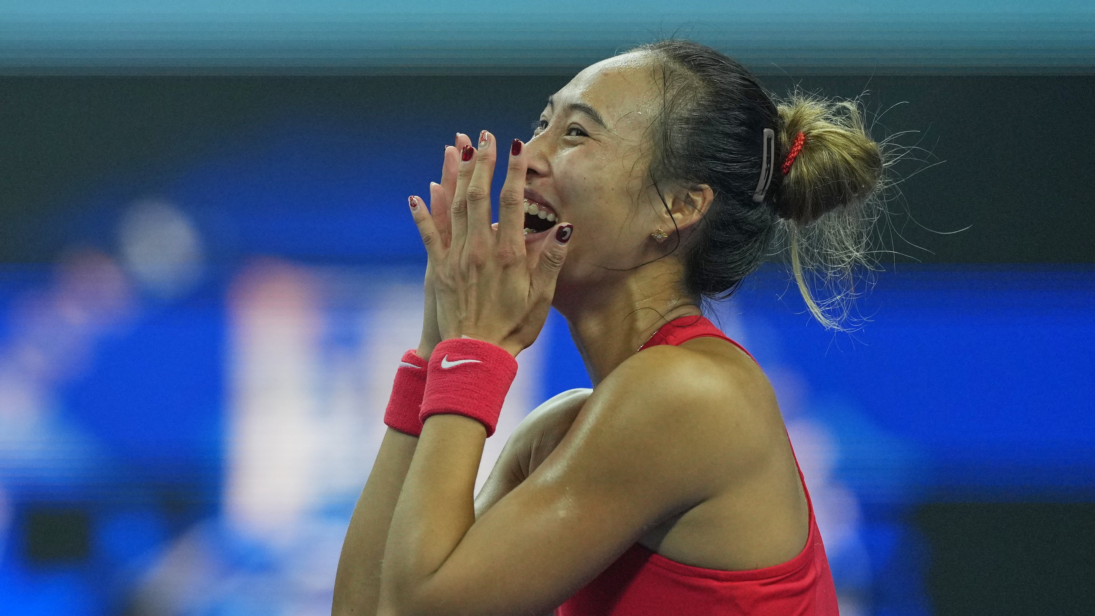 Zheng Qinwen, of China, celebrates after winning the women's singles final match against a Mirra Andreeva, of Russia at the China Open tennis tournament in Beijing, Sunday, Oct. 11, 2026. (AP Photo/Achmad Ibrahim)